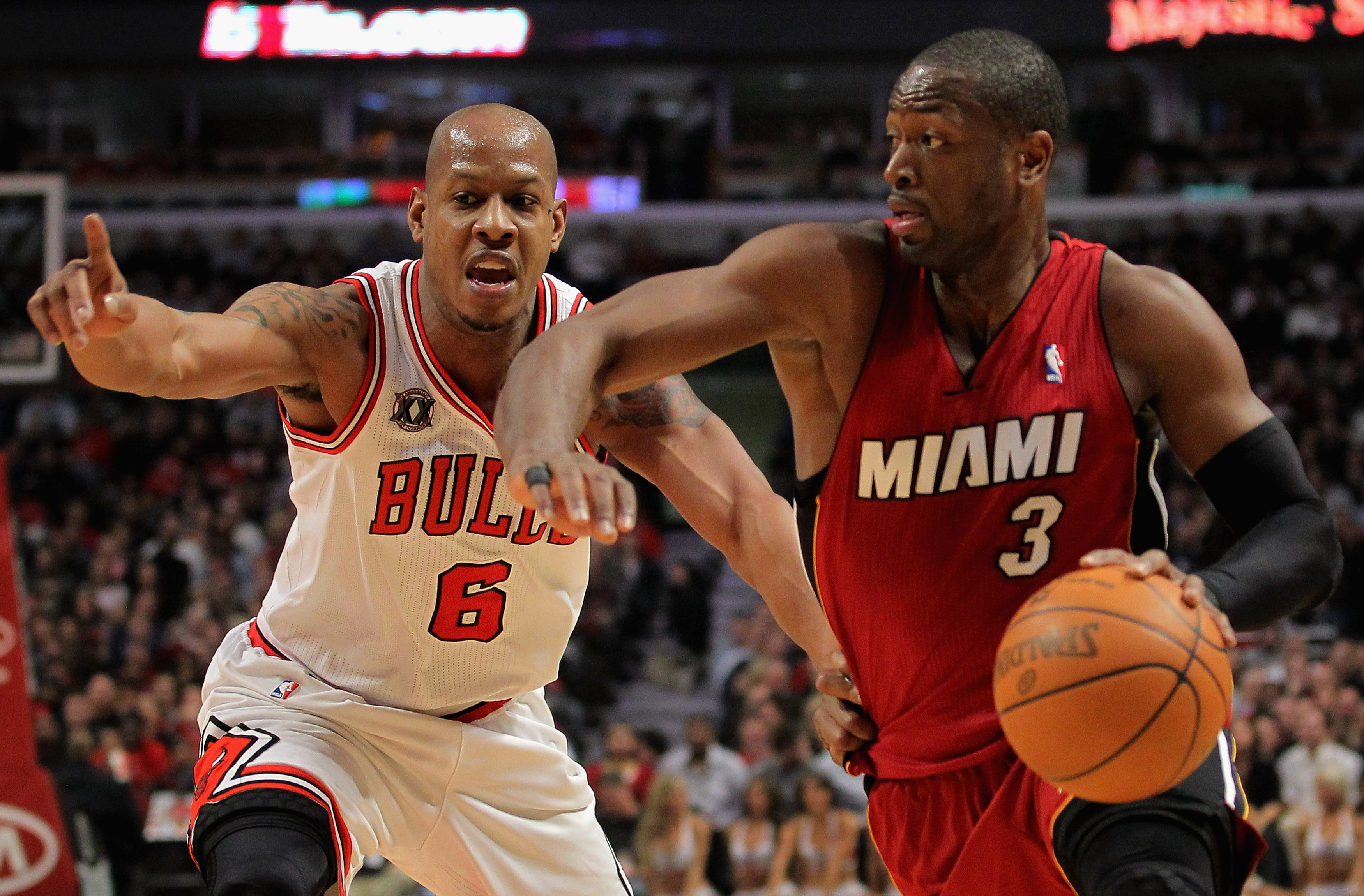 CHICAGO, IL - JANUARY 15:  Dwayne Wade #3 of the Miami Heat drives to the basket against Keith Bogans #6 of the Chicago Bulls at the United Center on January 15, 2011 in Chicago, Illinois. NOTE TO USER: User expressly acknowledges and agrees that, by down