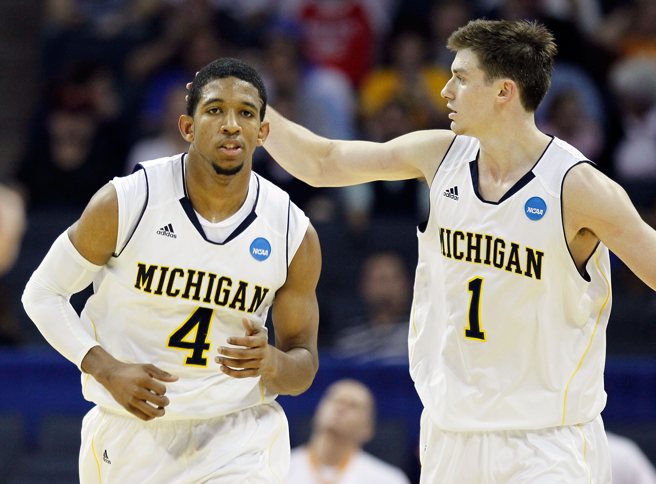 CHARLOTTE, NC - MARCH 18:  Darius Morris #4 and Stu Douglass #1 of the Michigan Wolverines react in the first half while taking on the Tennessee Volunteers during the second round of the 2011 NCAA men's basketball tournament at Time Warner Cable Arena on