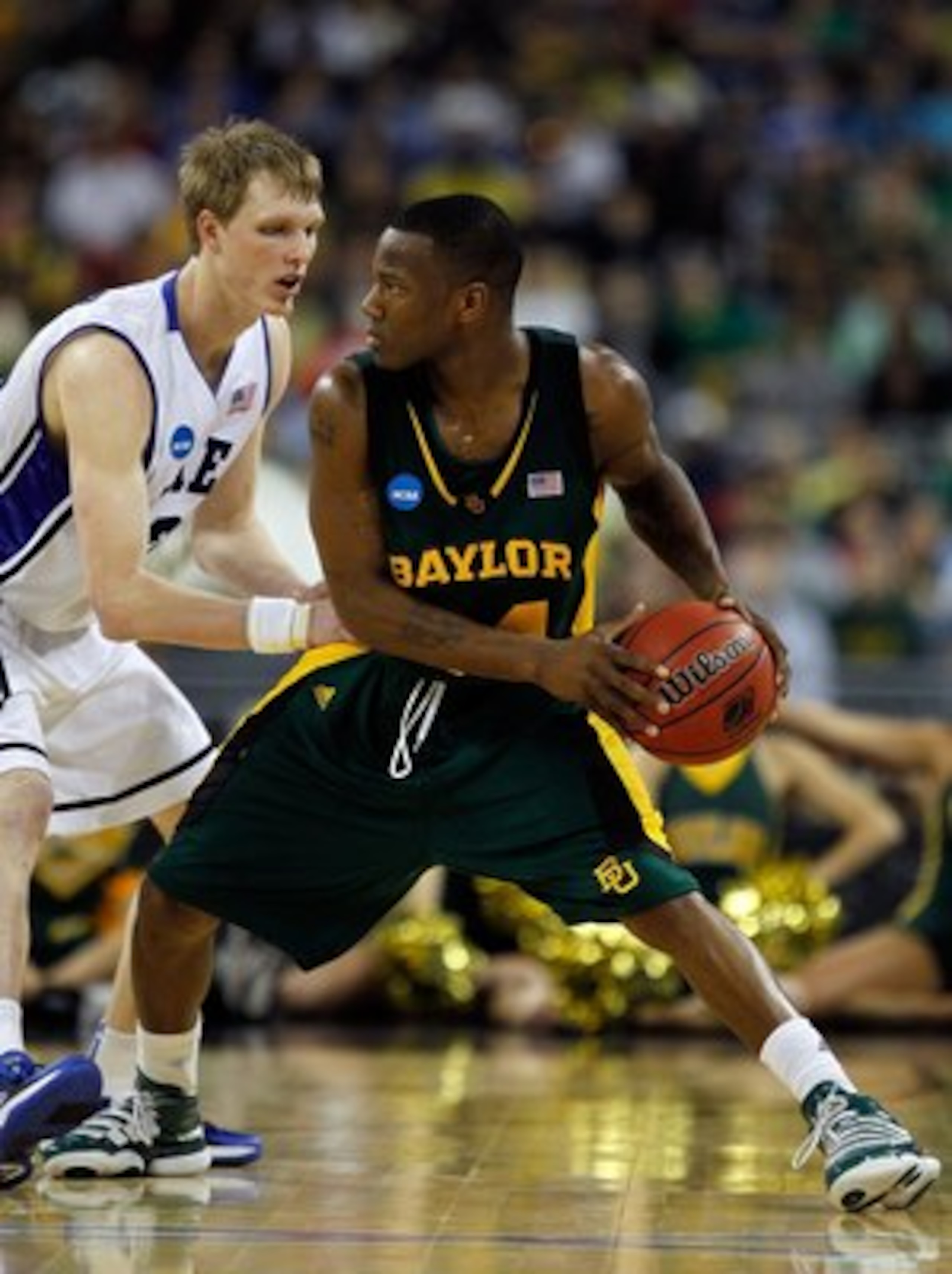 HOUSTON - MARCH 28: LaceDarius Dunn #24 of the Baylor Bears looks to pass under pressure from Kyle Singler #12 of the Duke Blue Devils during the south regional final of the 2010 NCAA men's basketball tournament at Reliant Stadium on March 28, 2010 in Hou