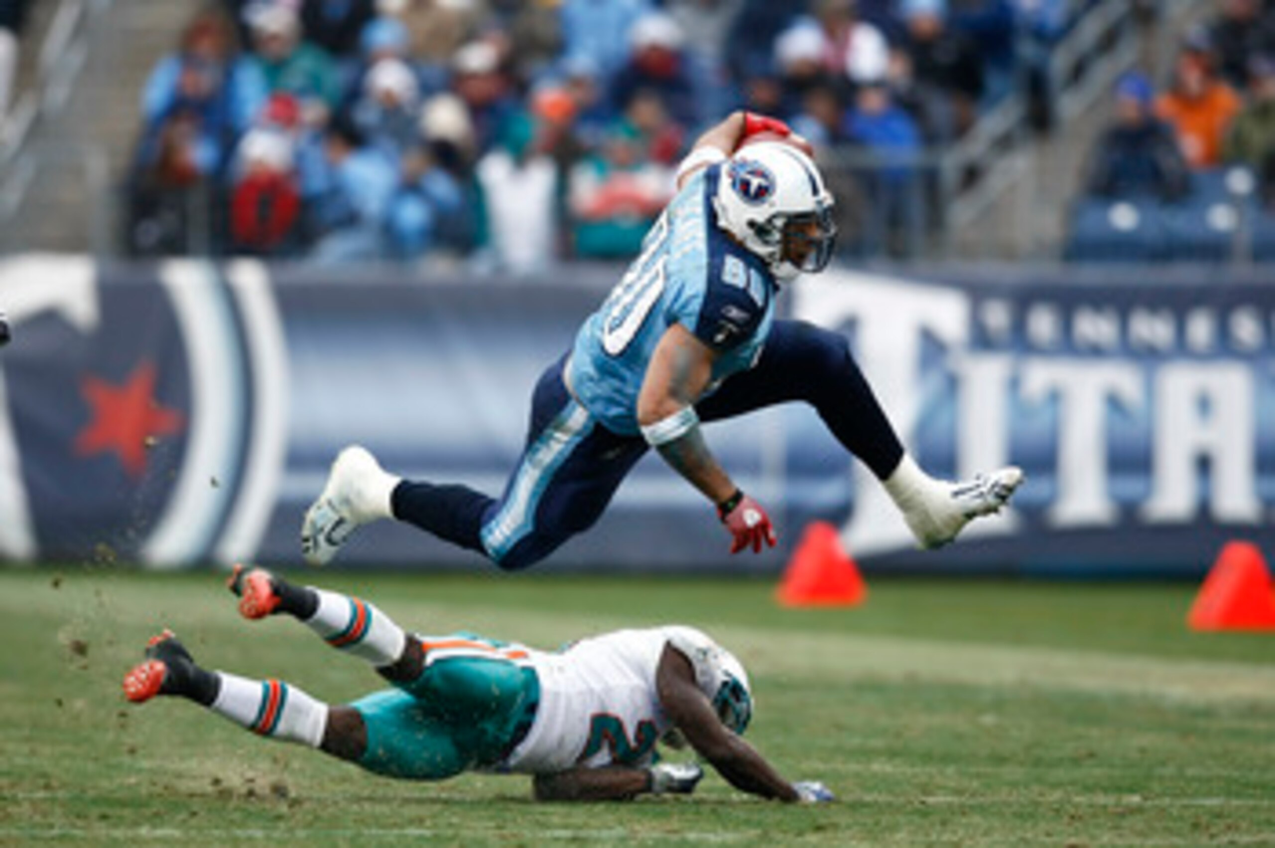 NASHVILLE, TN - DECEMBER 20: Bo Scaife #80 of the Tennessee Titans jumps over Vontae Davis #21 of the Miami Dolphins at LP Field on December 20, 2009 in Nashville, Tennessee. The Titans defeated the Dolphins 27-24 in overtime. (Photo by Joe Robbins/Getty 