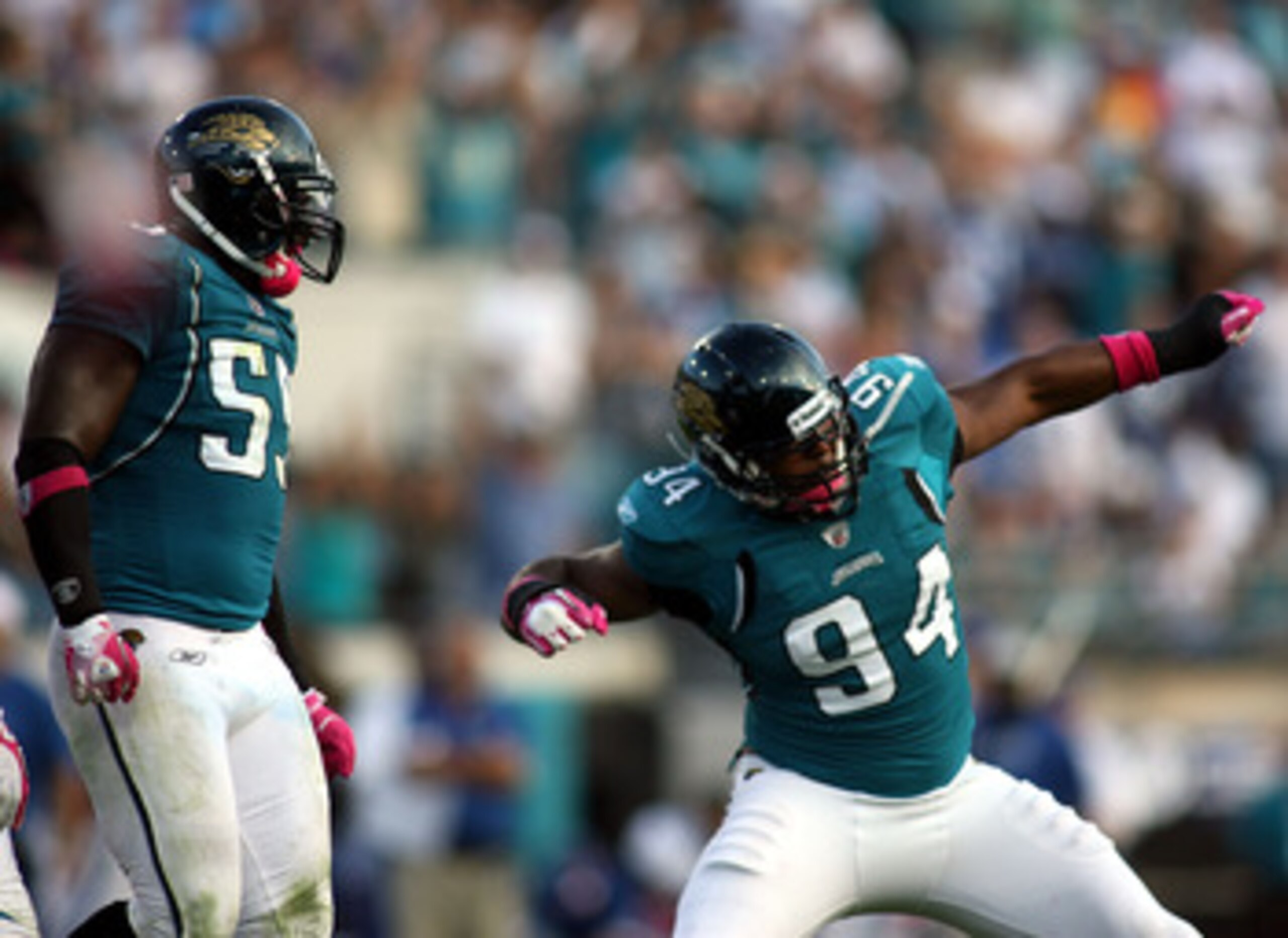 JACKSONVILLE, FL - OCTOBER 03:  Lineman Jeremy Mincey #94 of the Jacksonville Jaguars celebrates with Kirk Morreson after sacking Quarterback Peyton Manning #18 of the Indianapolis Colts at EverBank Field on October 3, 2010 in Jacksonville, Florida.  (Pho