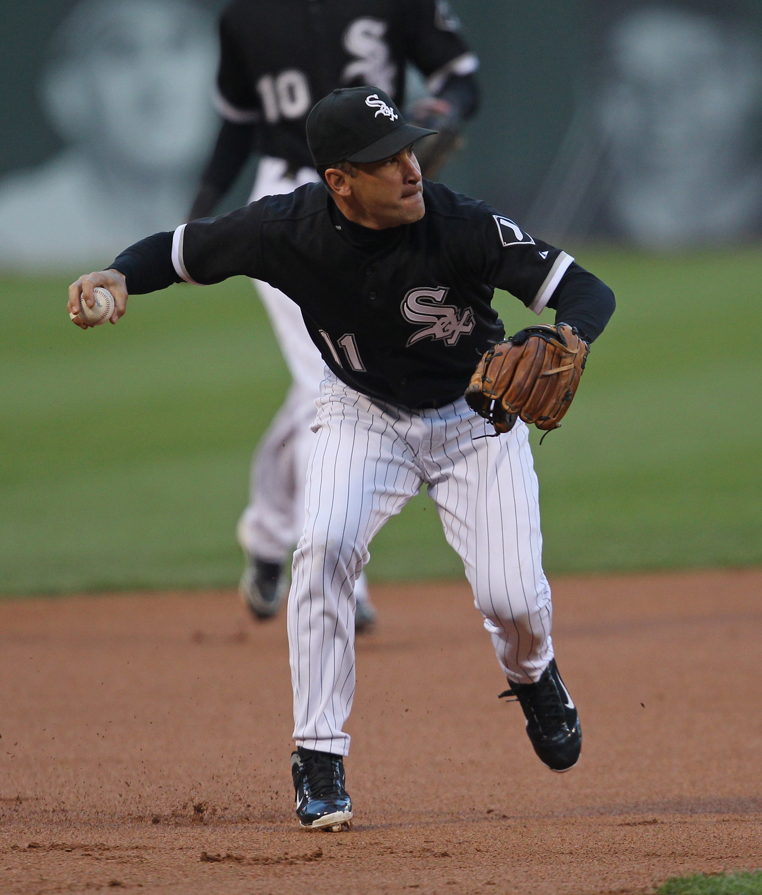 CHICAGO, IL - MAY 16: Omar Vizquel #11 of the Chicago White Sox throws to 1st base against the Texas Rangers at U.S. Cellular Field on May 16, 2011 in Chicago, Illinois. The Rangers defeated the White Sox 4-0. (Photo by Jonathan Daniel/Getty Images)