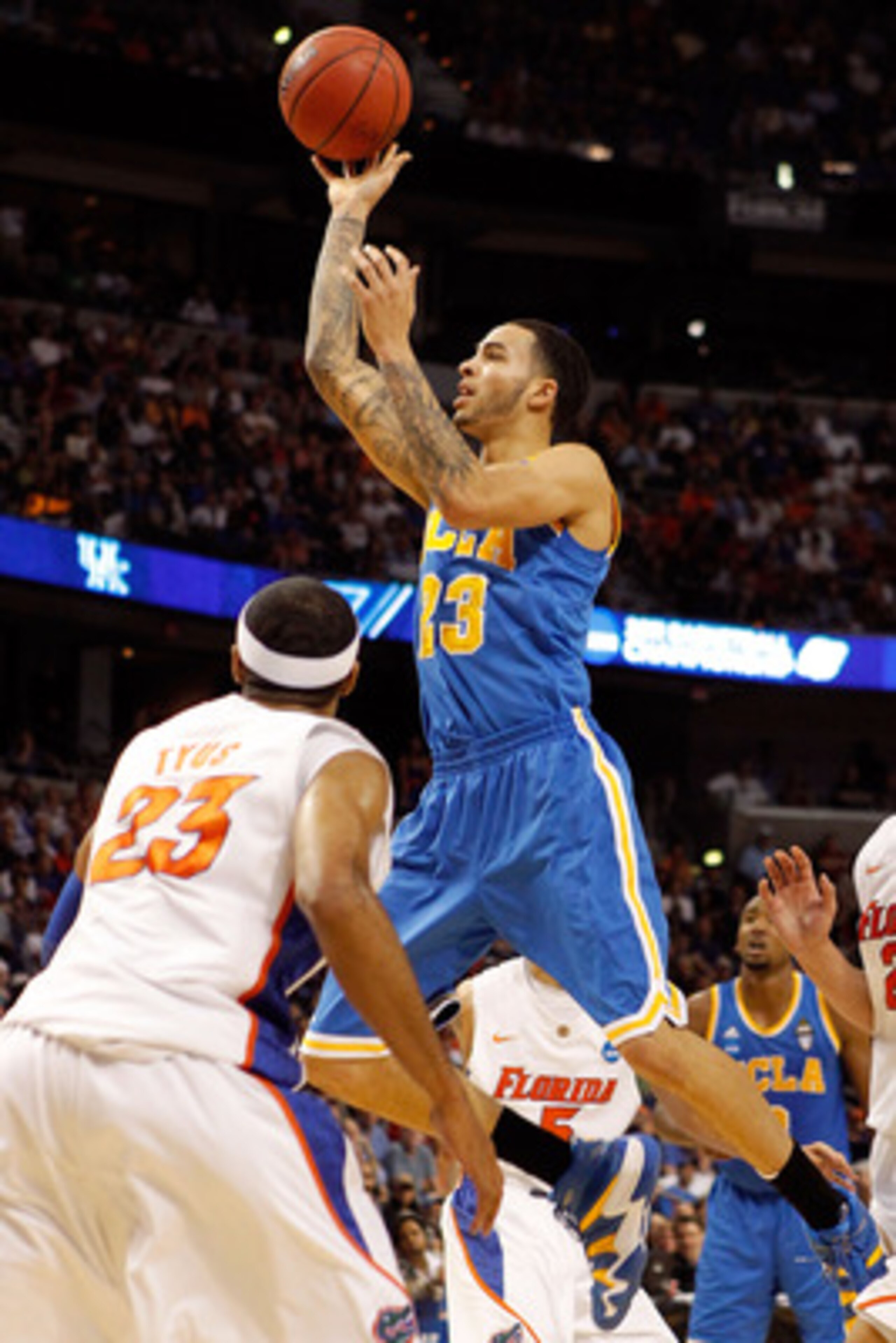 TAMPA, FL - MARCH 19:  Tyler Honeycutt #23 of the UCLA Bruins drives for a shot attempt against Alex Tyus #23 of the Florida Gators during the third round of the 2011 NCAA men's basketball tournament at St. Pete Times Forum on March 19, 2011 in Tampa, Flo