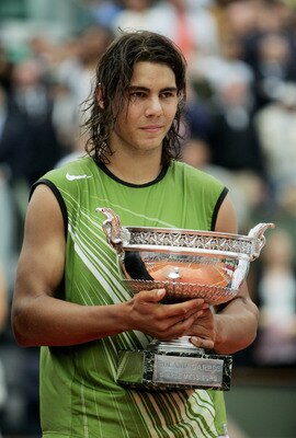 PARIS - JUNE 05:  Rafael Nadal of Spain celebrates with the trophy at the end of the Mens Final match on the fourteenth day of the French Open at Roland Garros on June 5, 2005 in Paris, France.  (Photo by Clive Mason/Getty Images)