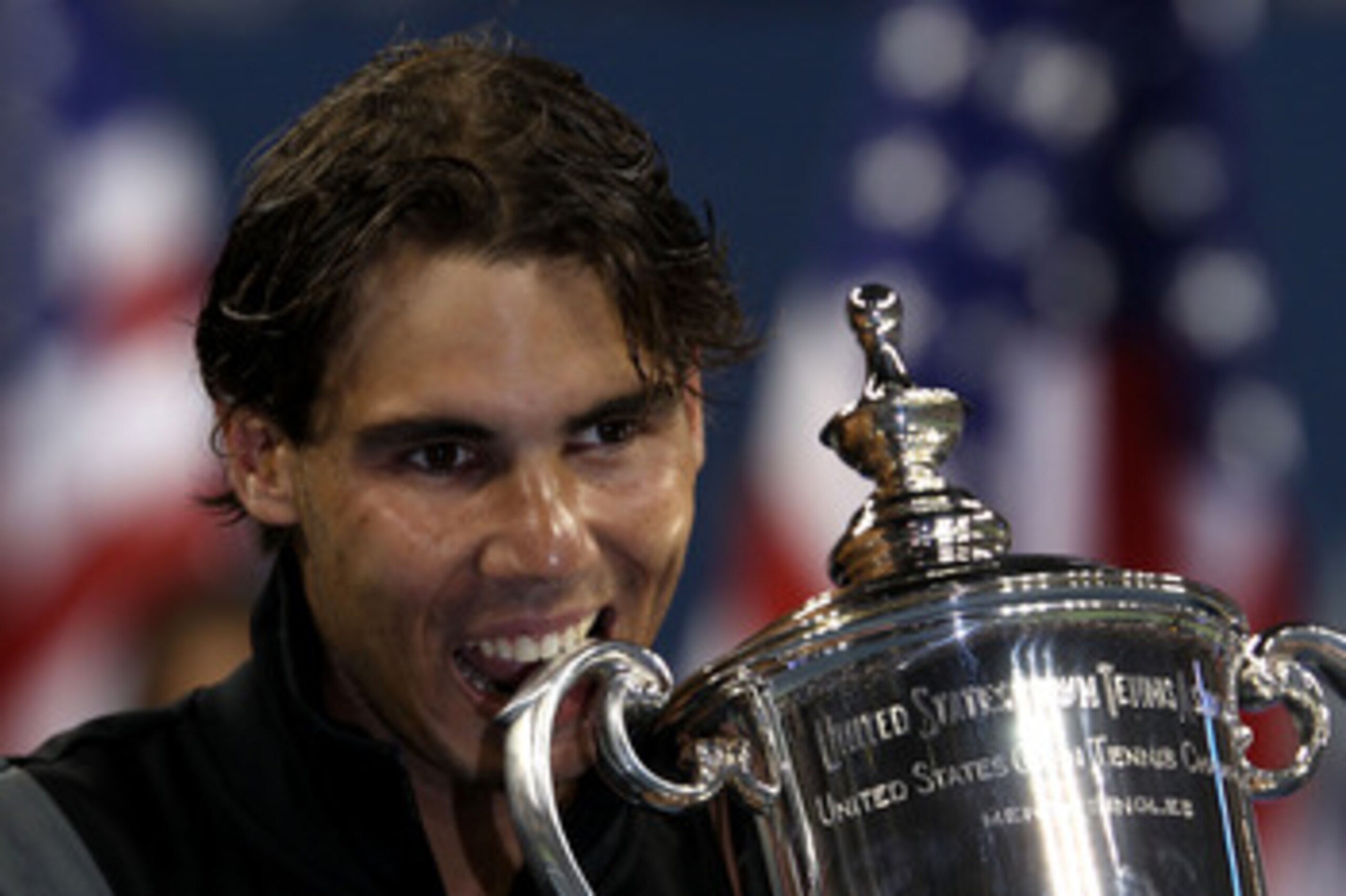 NEW YORK - SEPTEMBER 13: Rafael Nadal of Spain bites the championship trophy during the trophy ceremony after defeating Novak Djokovic of Serbia to win the men's singles final on day fifteen of the 2010 U.S. Open at the USTA Billie Jean King National Ten NEW YORK - SEPTEMBER 13: Rafael Nadal of Spain bites the championship trophy during the trophy ceremony after defeating Novak Djokovic of Serbia to win the men's singles final on day fifteen of the 2010 U.S. Open at the USTA Billie Jean King National Ten