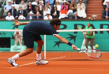 PARIS - JUNE 08:  Roger Federer of Switzerland stretches for a forehand during the Men's Singles Final match against Rafael Nadal of Spain on day fifteen of the French Open at Roland Garros on June 8, 2008 in Paris, France.  (Photo by Mike Hewitt/Getty Im
