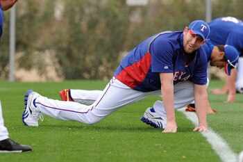 SURPRISE, AZ - FEBRUARY 18:  Brandon Webb #33 of the Texas Rangers stretches prior to spring workouts at Surprise Stadium on February 18, 2011 in Surprise, Arizona.  (Photo by Norm Hall/Getty Images)