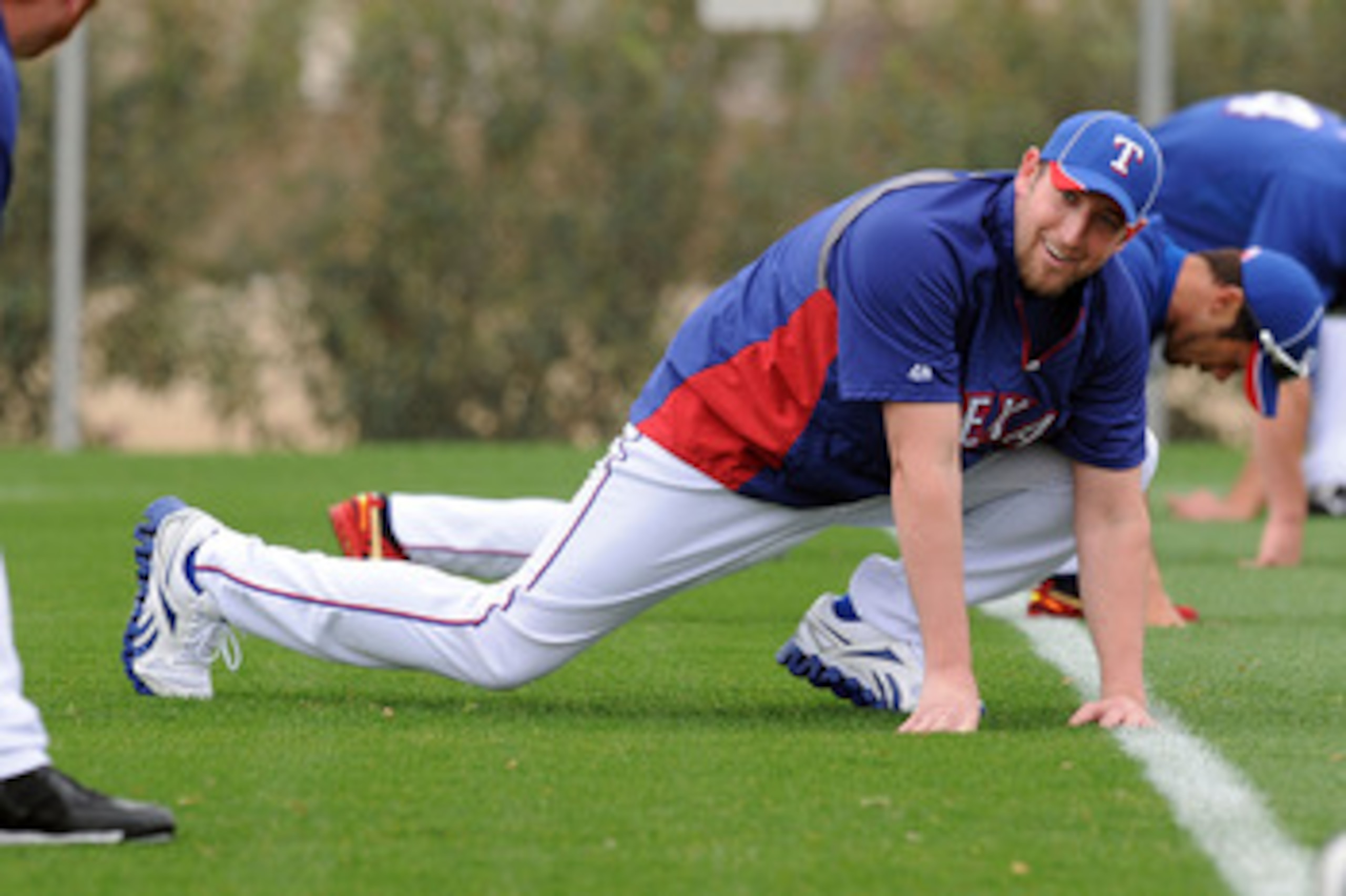 SURPRISE, AZ - FEBRUARY 18:  Brandon Webb #33 of the Texas Rangers stretches prior to spring workouts at Surprise Stadium on February 18, 2011 in Surprise, Arizona.  (Photo by Norm Hall/Getty Images)
