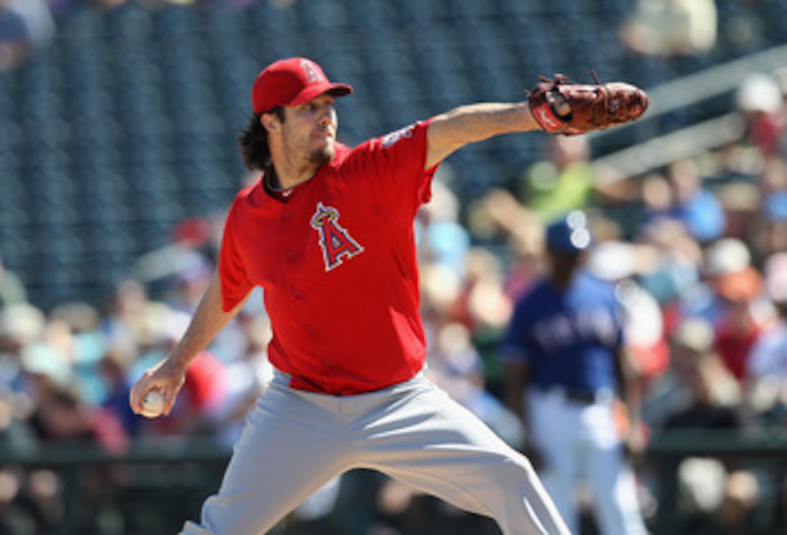SURPRISE, AZ - MARCH 02:  Starting pitcher Dan Haren #24 of the Los Angeles Angels of Anaheim pitches against the Texas Rangers during the spring training game at Surprise Stadium on March 2, 2011 in Surprise, Arizona.  (Photo by Christian Petersen/Getty