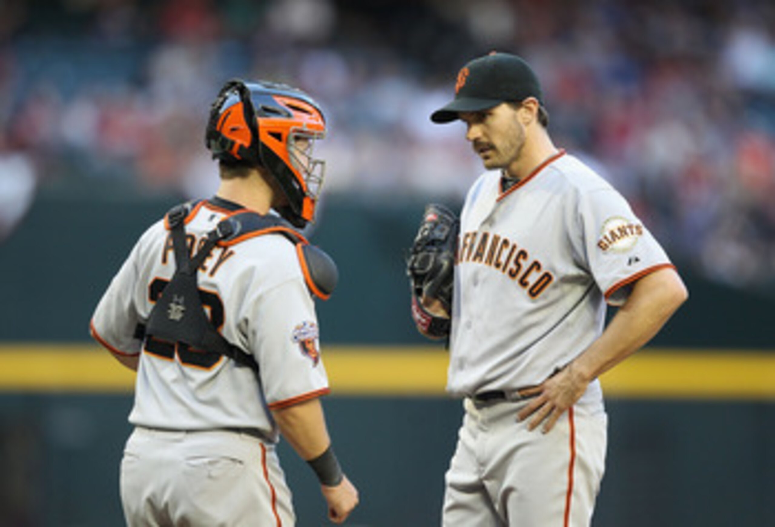 PHOENIX, AZ - APRIL 16:  Catcher Buster Posey #28 and starting pitcher Barry Zito #75 of the San Francisco Giants talk during the Major League Baseball game against the Arizona Diamondbacks at Chase Field on April 16, 2011 in Phoenix, Arizona.  The Giants