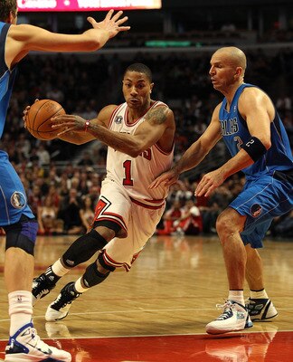 CHICAGO, IL - JANUARY 20: Derrick Rose #1 of the Chicago Bulls drives between Jason Kidd #2 and Dirk Nowitzki #41 of the Dallas Mavericks at the United Center on January 20, 2011 in Chicago, Illinois. The Bulls defeated the Mavericks 82-77. NOTE TO USER: