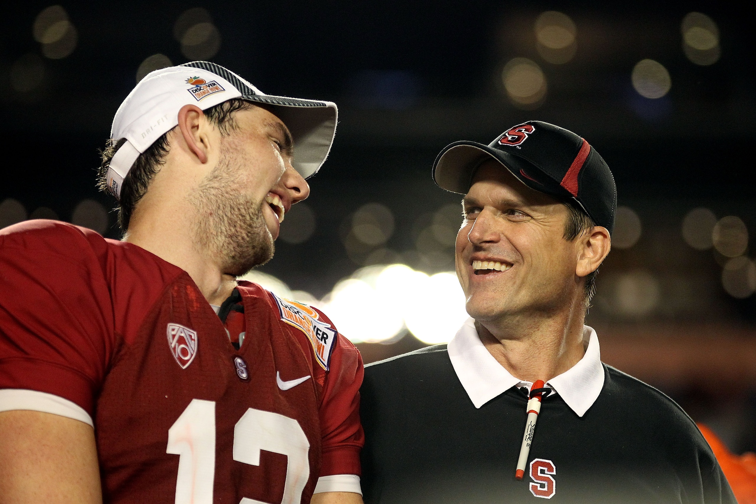 MIAMI, FL - JANUARY 03:  (L-R) Quarterback Andrew Luck and head coach Jim Harbaugh of the Stanford Cardinal celebrate on stage after Stanford won 40-12 against the Virginai Tech Hokies during the 2011 Discover Orange Bowl at Sun Life Stadium on January 3,