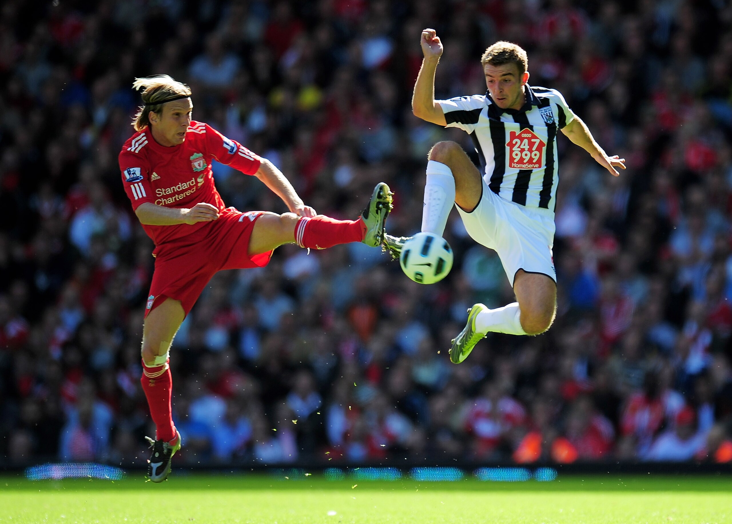 LIVERPOOL, ENGLAND - AUGUST 29:  James Morrison of West Bromwich Albion is challenged by Christian Poulsen of Liverpool during the Barclays Premier League match between Liverpool and West Bromwich Albion at Anfield on August 29, 2010 in Liverpool, England