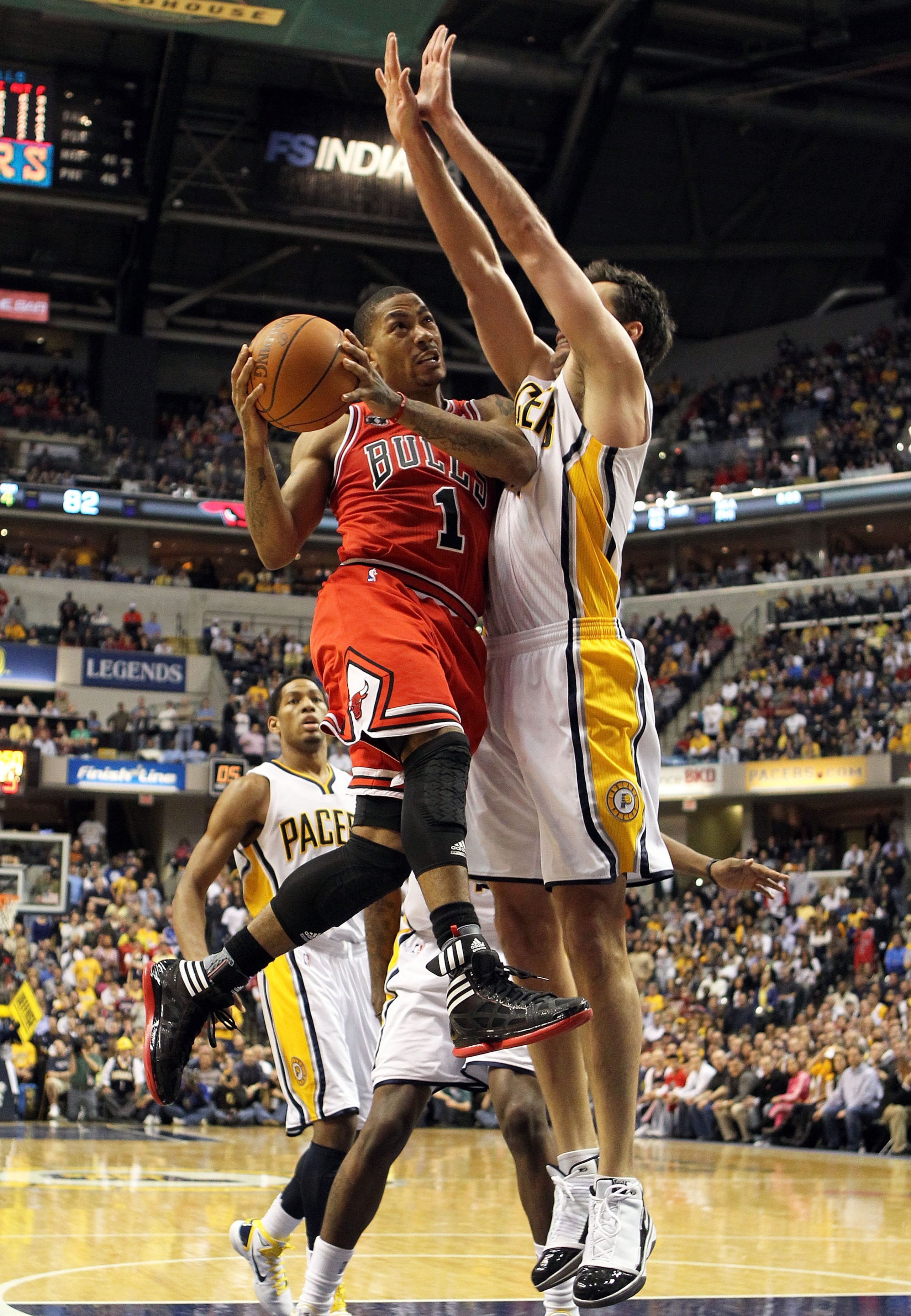 INDIANAPOLIS, IN - APRIL 21: Derrick Rose #1 of the Chicago Bulls shoots the ball while defended by Jeff Foster #10 of the Indiana Pacers in Game three of the Eastern Conference Quarterfinals in the 2011 NBA Playoffs on April 21, 2011 at Conseco Fieldho INDIANAPOLIS, IN - APRIL 21: Derrick Rose #1 of the Chicago Bulls shoots the ball while defended by Jeff Foster #10 of the Indiana Pacers in Game three of the Eastern Conference Quarterfinals in the 2011 NBA Playoffs on April 21, 2011 at Conseco Fieldho