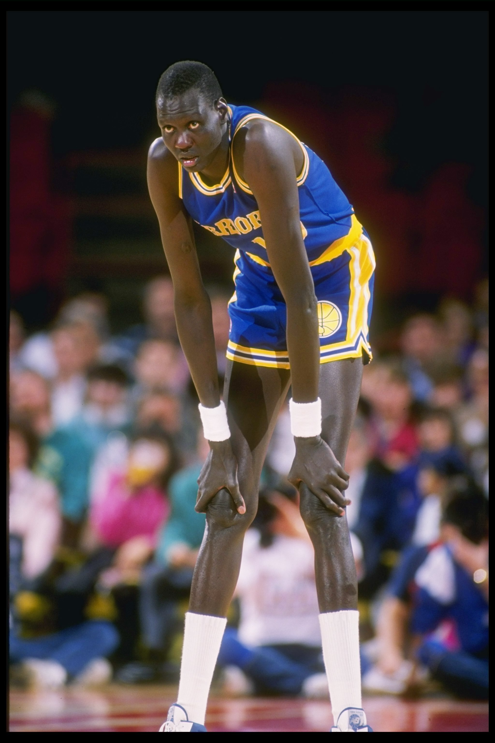 1989-1990:  Manute Bol of the Golden State Warriors looks on during a basketball game. Mandatory Credit: Tim de Frisco  /Allsport