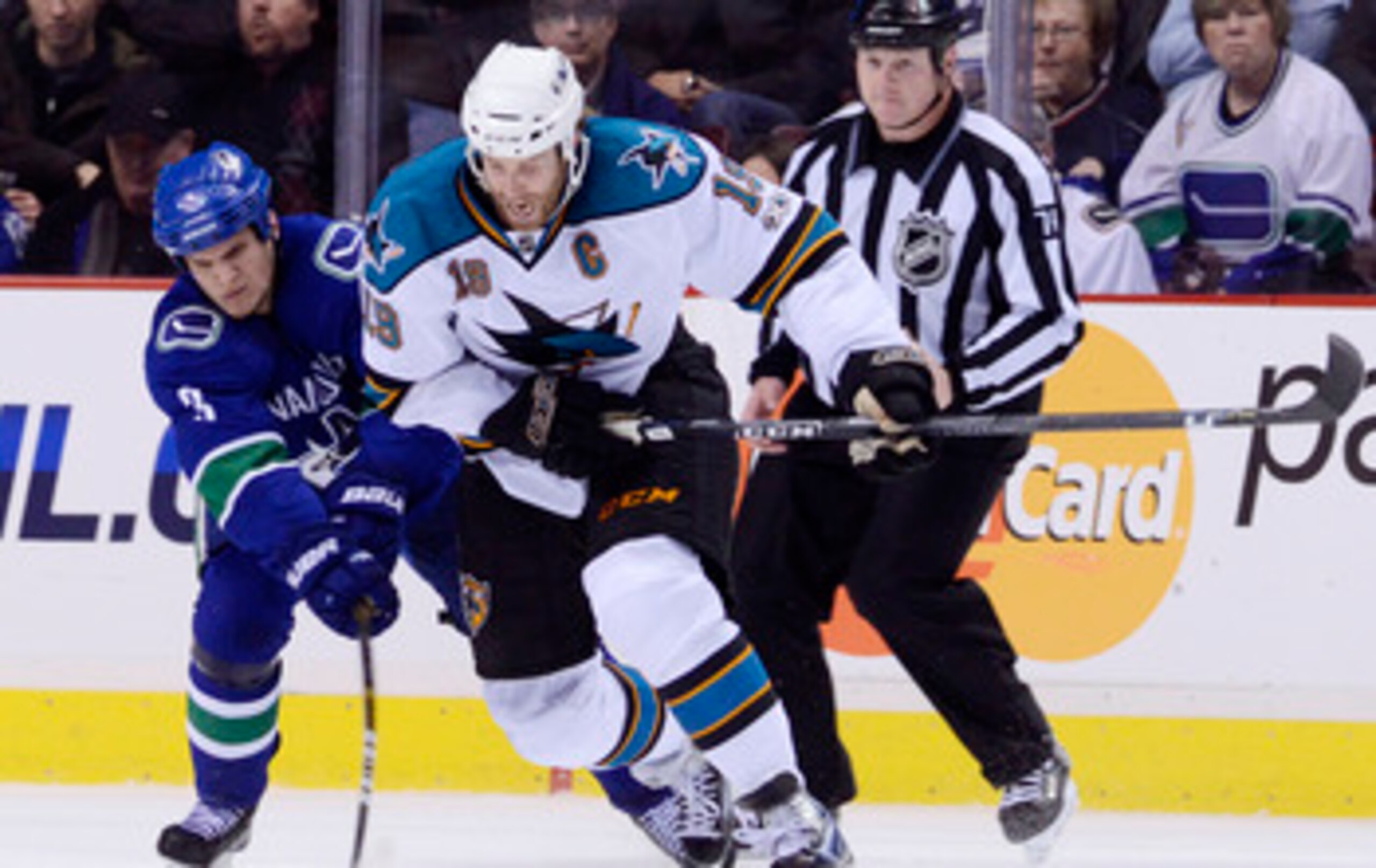 VANCOUVER, CANADA - JANUARY 20: Kevin Bieksa #3 of the Vancouver Canucks gets his stick on the puck while trying to defend against Joe Thornton #19 of the San Jose Sharks during the second period in NHL action on January 20, 2011 at Rogers Arena in Vancou VANCOUVER, CANADA - JANUARY 20: Kevin Bieksa #3 of the Vancouver Canucks gets his stick on the puck while trying to defend against Joe Thornton #19 of the San Jose Sharks during the second period in NHL action on January 20, 2011 at Rogers Arena in Vancou