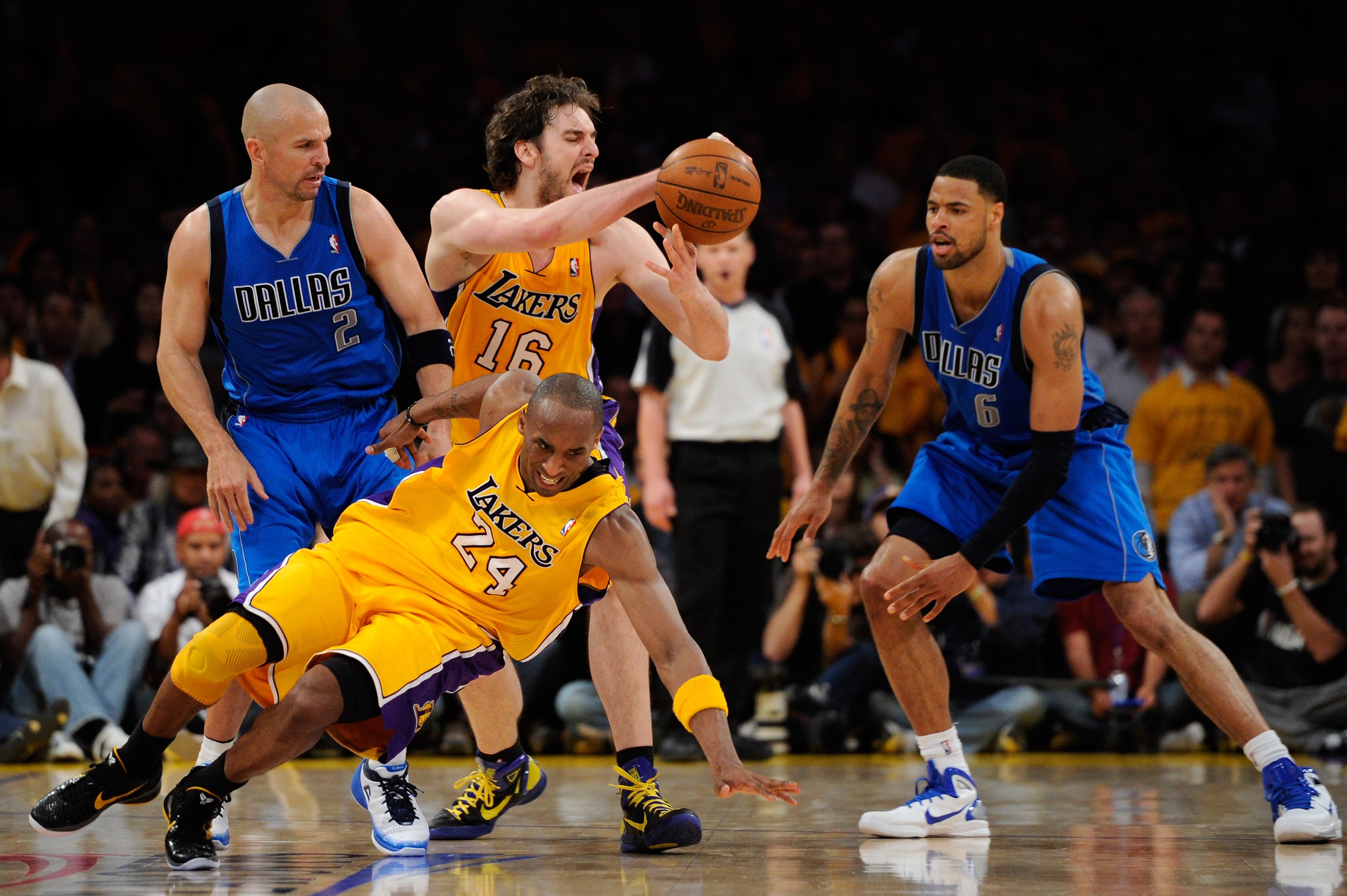 LOS ANGELES, CA - MAY 02:  Kobe Bryant #24 of the Los Angeles Lakers falls down as Pau Gasol #16 looses the ball in front of Jason Kidd #2 and Tyson Chandler #6 of the Dallas Mavericks late in the fourth quarter in Game One of the Western Conference Semif