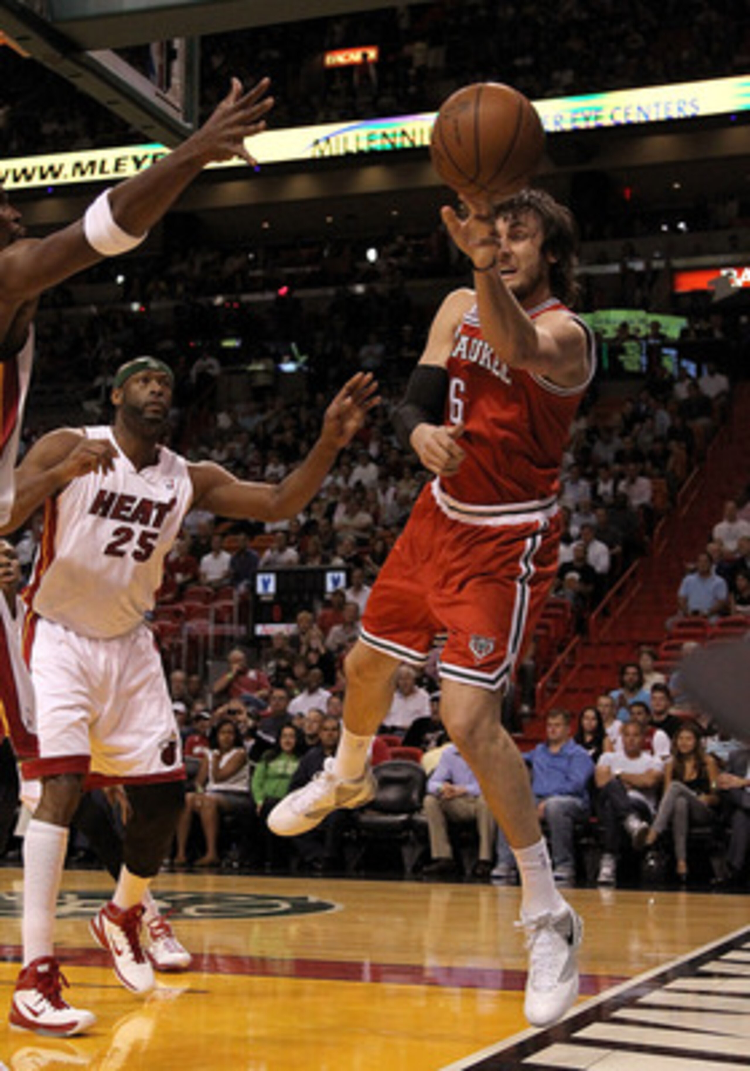 MIAMI, FL - APRIL 06:  Andrew Bogut #6 of the Milwaukee Bucks passes away from  Eric Dampier #25 of the Miami Heat during a game at American Airlines Arena on April 6, 2011 in Miami, Florida. NOTE TO USER: User expressly acknowledges and agrees that, by d