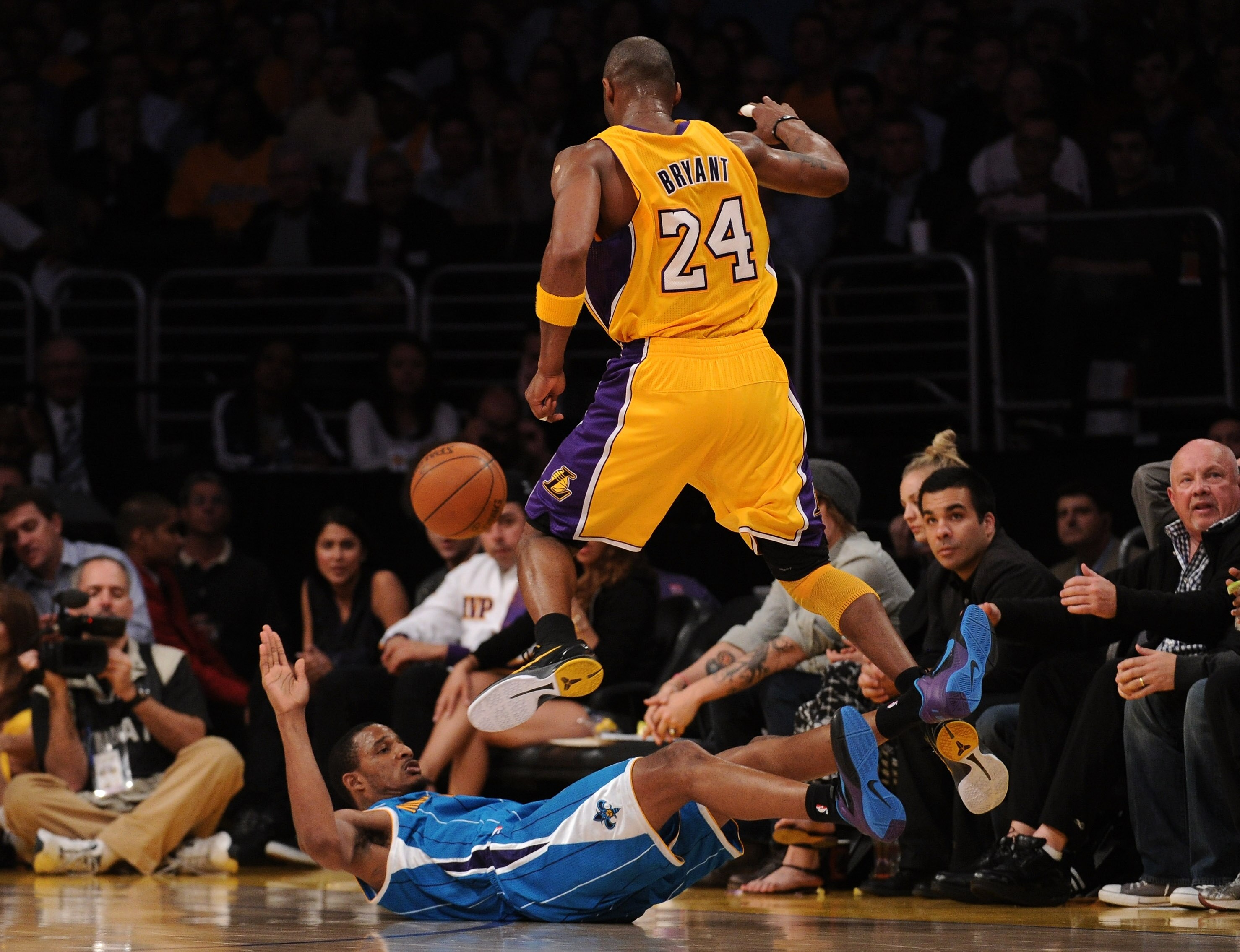 LOS ANGELES, CA - APRIL 26:  Trevor Ariza #1 of the New Orleans Hornets is called for a blocking foul as he is knocked down by Kobe Bryant #24 of the Los Angeles Lakers in the third quarter in Game Five of the Western Conference Quarterfinals in the 2011