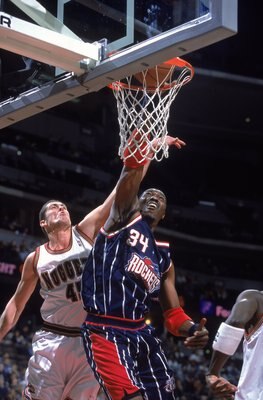30 Nov 2000:  Hakeem Olajuwon #34 of the Houston Rockets dunks the ball against Raef LaFrantz #45 of the Denver Nuggets during the game at the Pepsi Center in Denver, Colorado.  The Nuggets defeated the Rockets 109-105.  NOTE TO USER: It is expressly unde