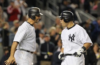 NEW YORK, NY - MAY 13:  Jorge Posada #20 of the New York Yankees congratulates Russell Martin #55 after Martin hits a a two run home run against the Boston Red Sox during their game on May 13, 2011 at Yankee Stadium in the Bronx borough of New York City.