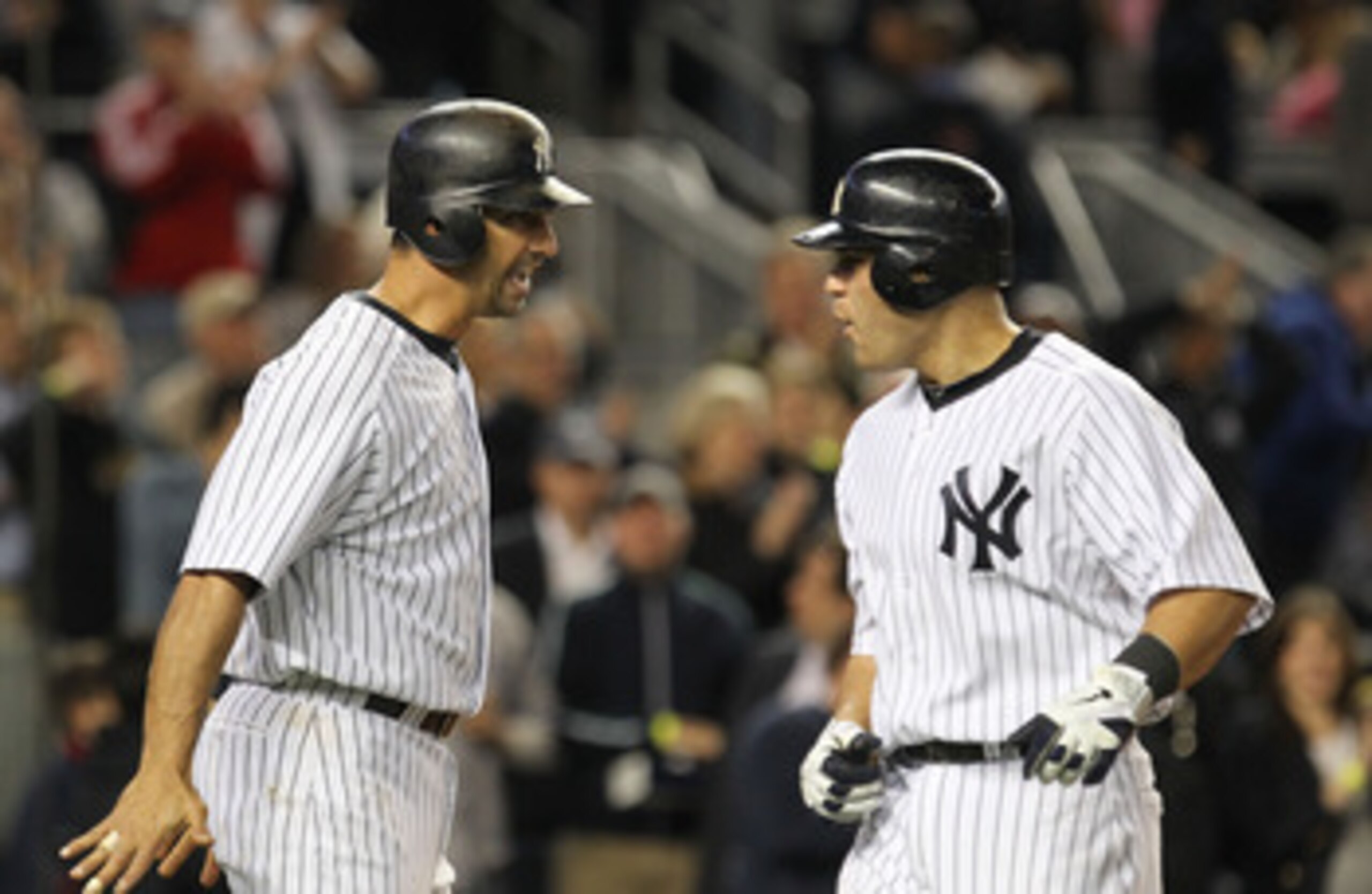 NEW YORK, NY - MAY 13:  Jorge Posada #20 of the New York Yankees congratulates Russell Martin #55 after Martin hits a a two run home run against the Boston Red Sox during their game on May 13, 2011 at Yankee Stadium in the Bronx borough of New York City.