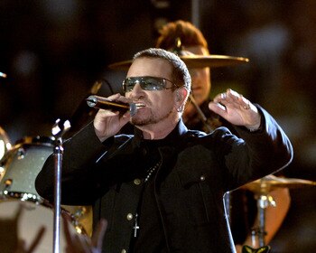 Bono of U2 performs  during a pre-game  concert inside  the Louisana Superdome before  the ESPN Monday Night Football  game September 25, 2006 in New Orleans. (Photo by Al Messerschmidt/Getty Images)