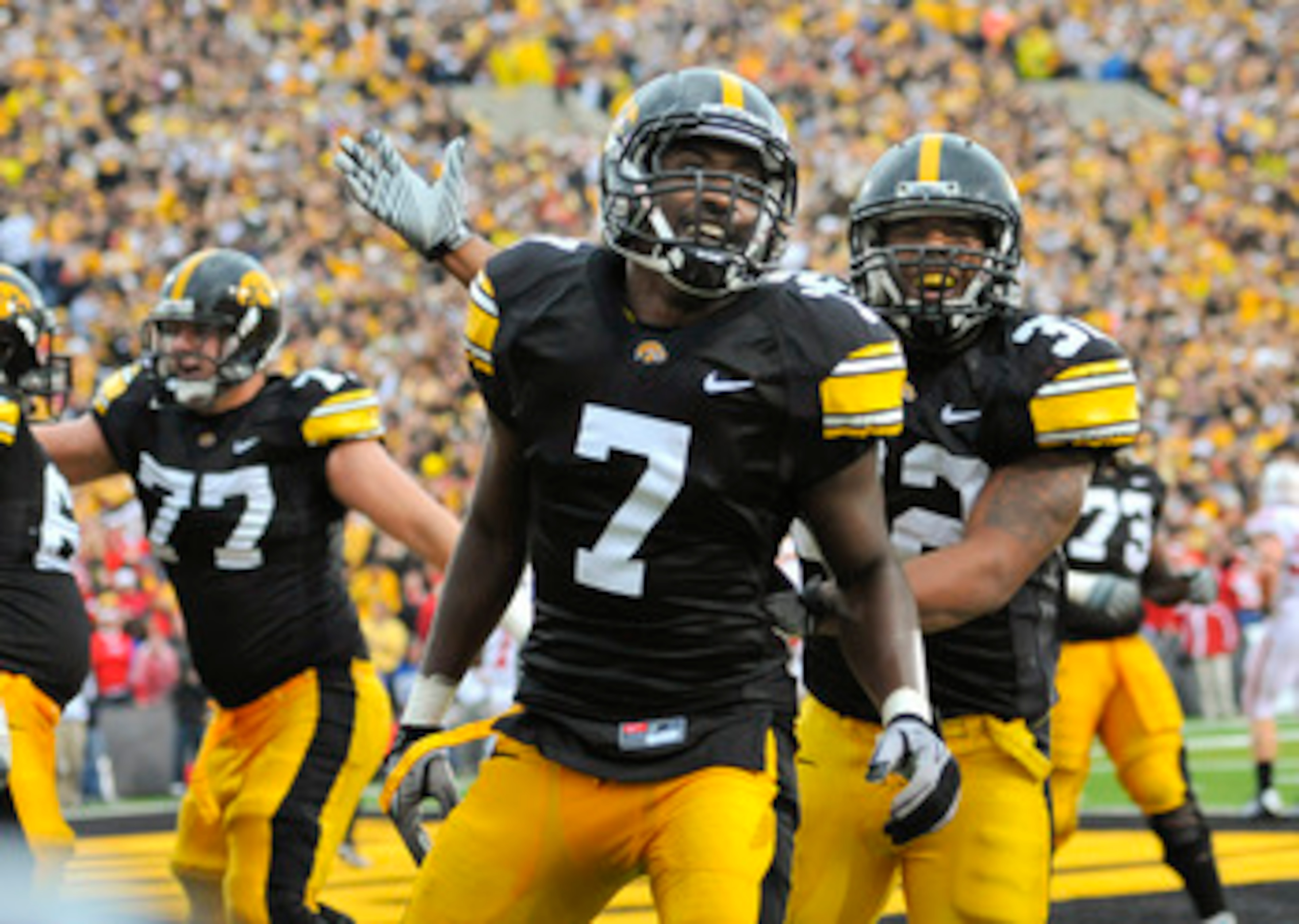 IOWA CITY, IA - OCTOBER 23- Wide receiver Marvin McNutt Jr. #7 of the University of Iowa Hawkeyes celebrates with teammate running back Adam Robinson #32 after scoring a touchdown against the Wisconsin Badgers during the second half of play at Kinnick Sta