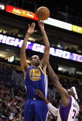 PHOENIX, AZ - FEBRUARY 10:  Brandan Wright #32 of the Golden State Warriors puts up a shot over Hakim Warrick #21 of the Phoenix Suns during the NBA game at US Airways Center on February 10, 2011 in Phoenix, Arizona. The Suns defeated the Warriors 112-88.
