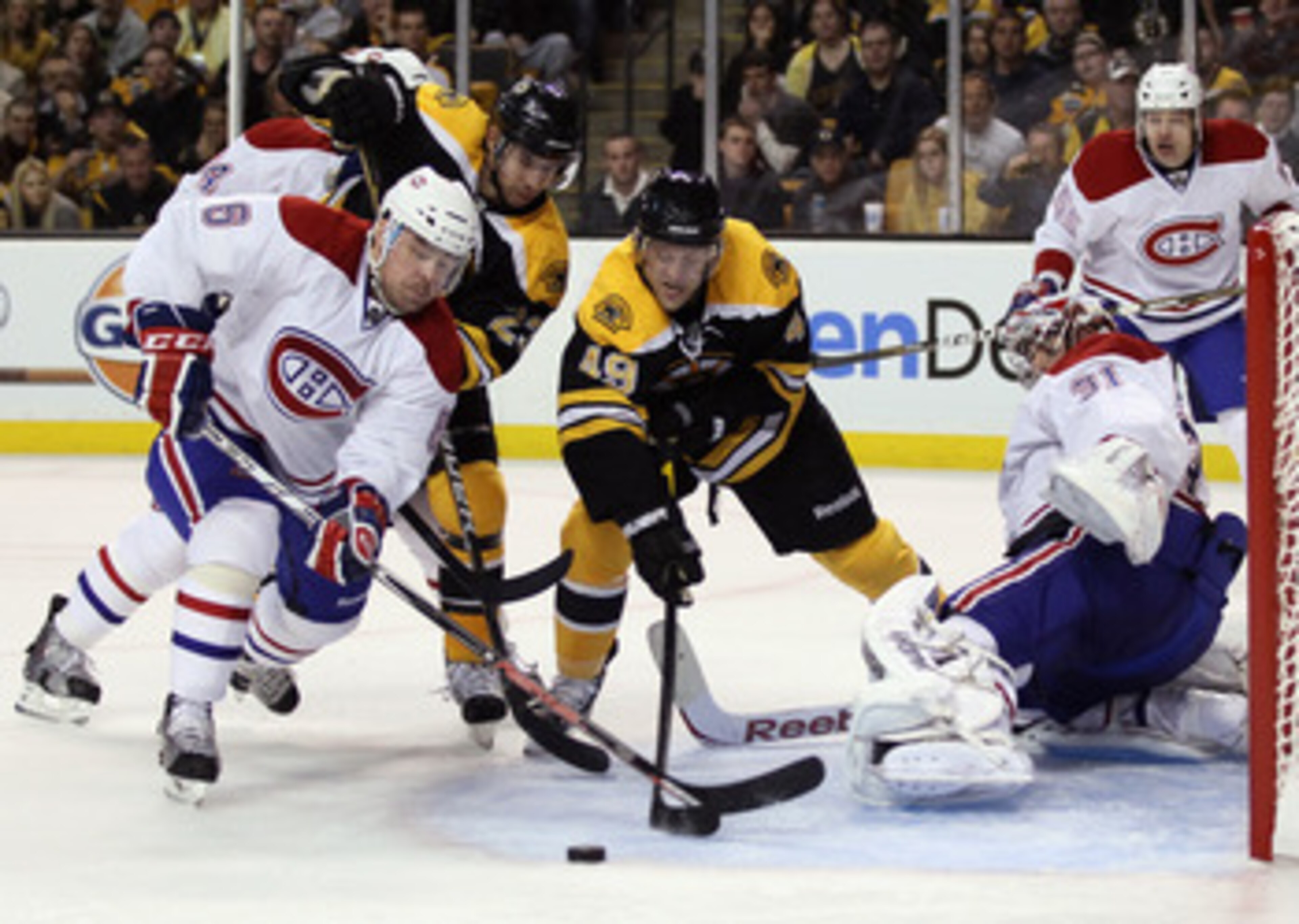 BOSTON, MA - APRIL 14:  Rich Peverley #49 of the Boston Bruins tries to get the puck past Carey Price #31 of the Montreal Canadiens as teammate Jaroslav Spacek #6 defends in Game One of the Eastern Conference Quarterfinals during the 2011 NHL Stanley Cup