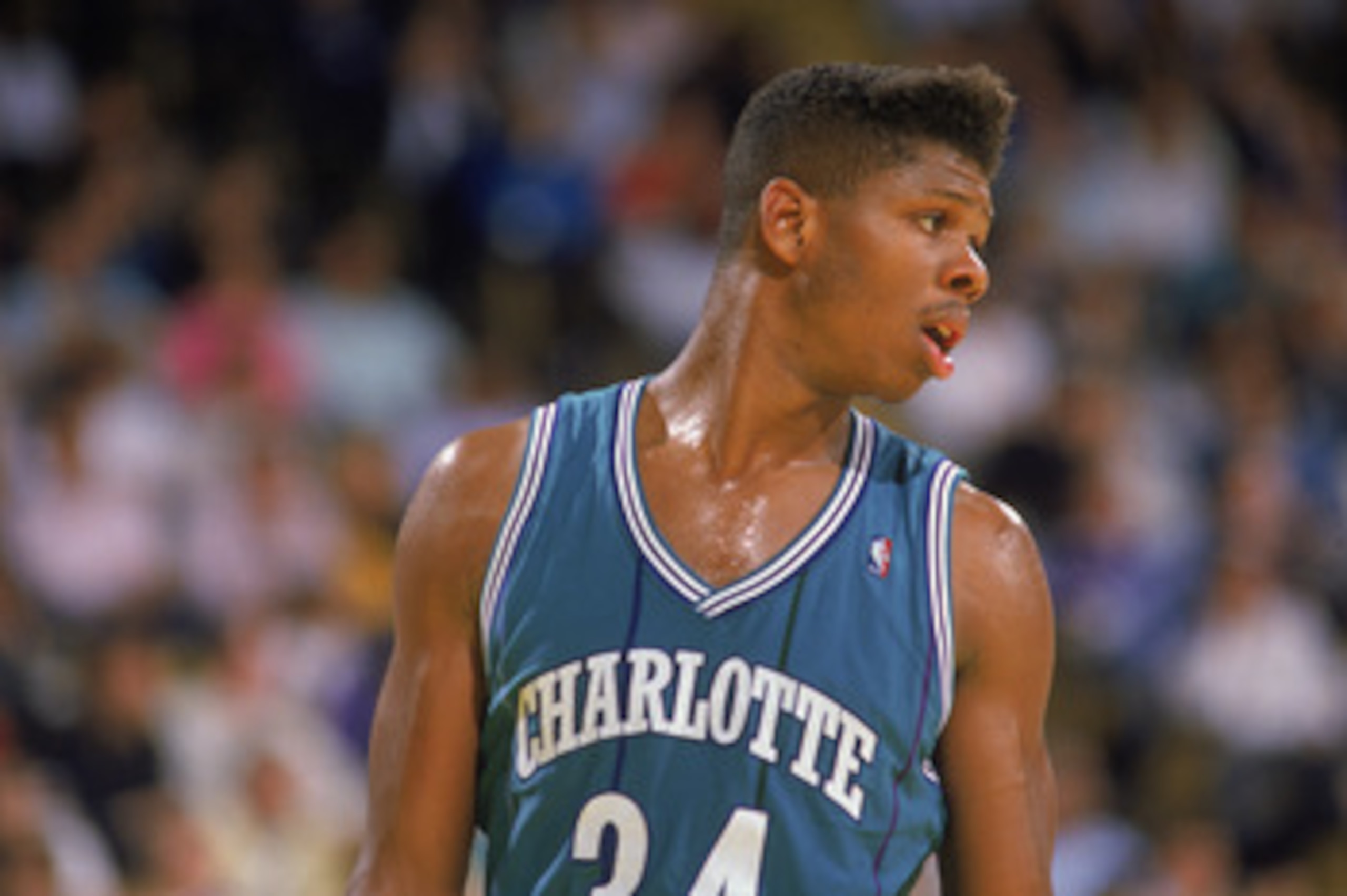 CHARLOTTE, NC - 1989:  J.R. Reid #34 of the Charlotte Hornets stands on the court during an NBA game at Charlotte Colesium in 1989. (Photo by Mike Powell/Getty Images)