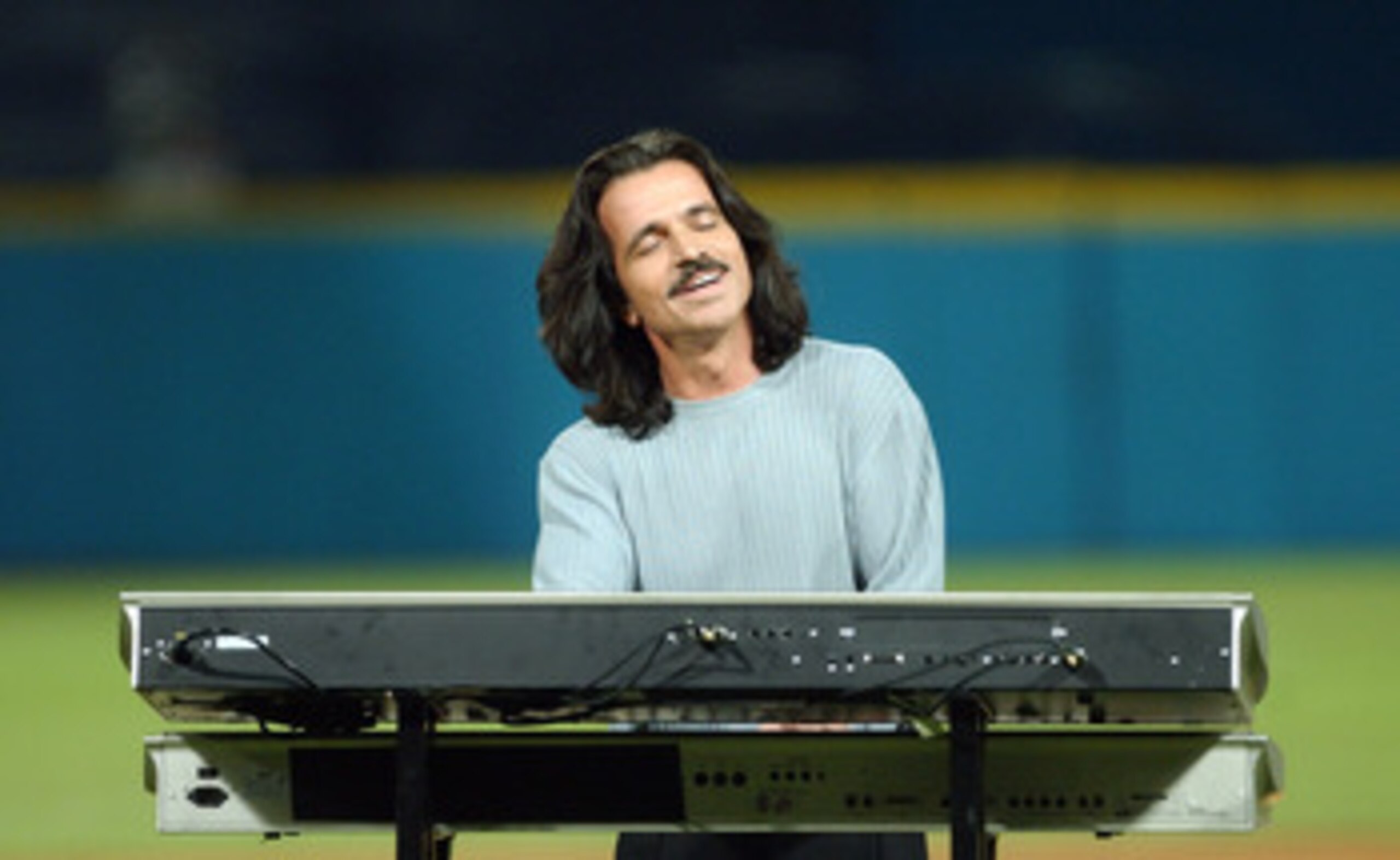 MIAMI - OCTOBER 23:  Recording artist Yanni performs the National Anthem prior to game five of the Major League Baseball World Series between the New York Yankees and the Florida Marlins on October 23, 2003 at Pro Player Stadium in Miami, Florida.  (Photo