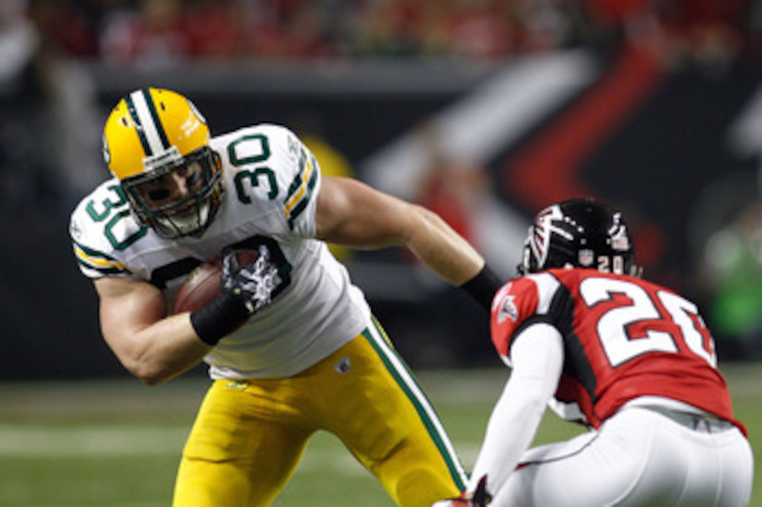 ATLANTA, GA - JANUARY 15:  John Kuhn #30 of the Green Bay Packers runs the ball against the Atlanta Falcons during their 2011 NFC divisional playoff game at Georgia Dome on January 15, 2011 in Atlanta, Georgia. The Packers won 48-21. (Photo by Chris Grayt