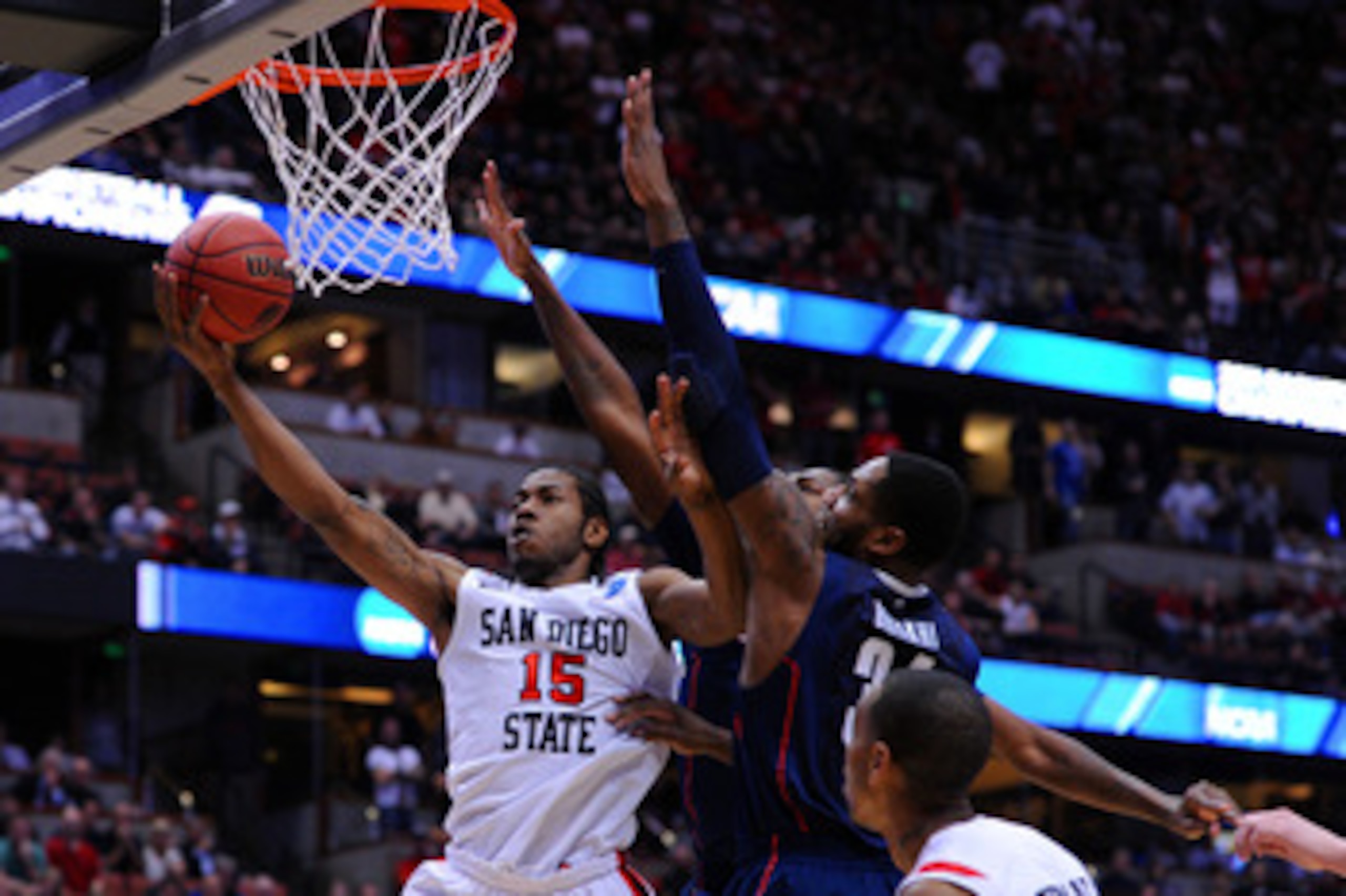 ANAHEIM, CA - MARCH 24:  Kawhi Leonard #15 of the San Diego State Aztecs goes to the hoop against Alex Oriakhi #34 of the Connecticut Huskies during the west regional semifinal of the 2011 NCAA men's basketball tournament at the Honda Center on March 24, 