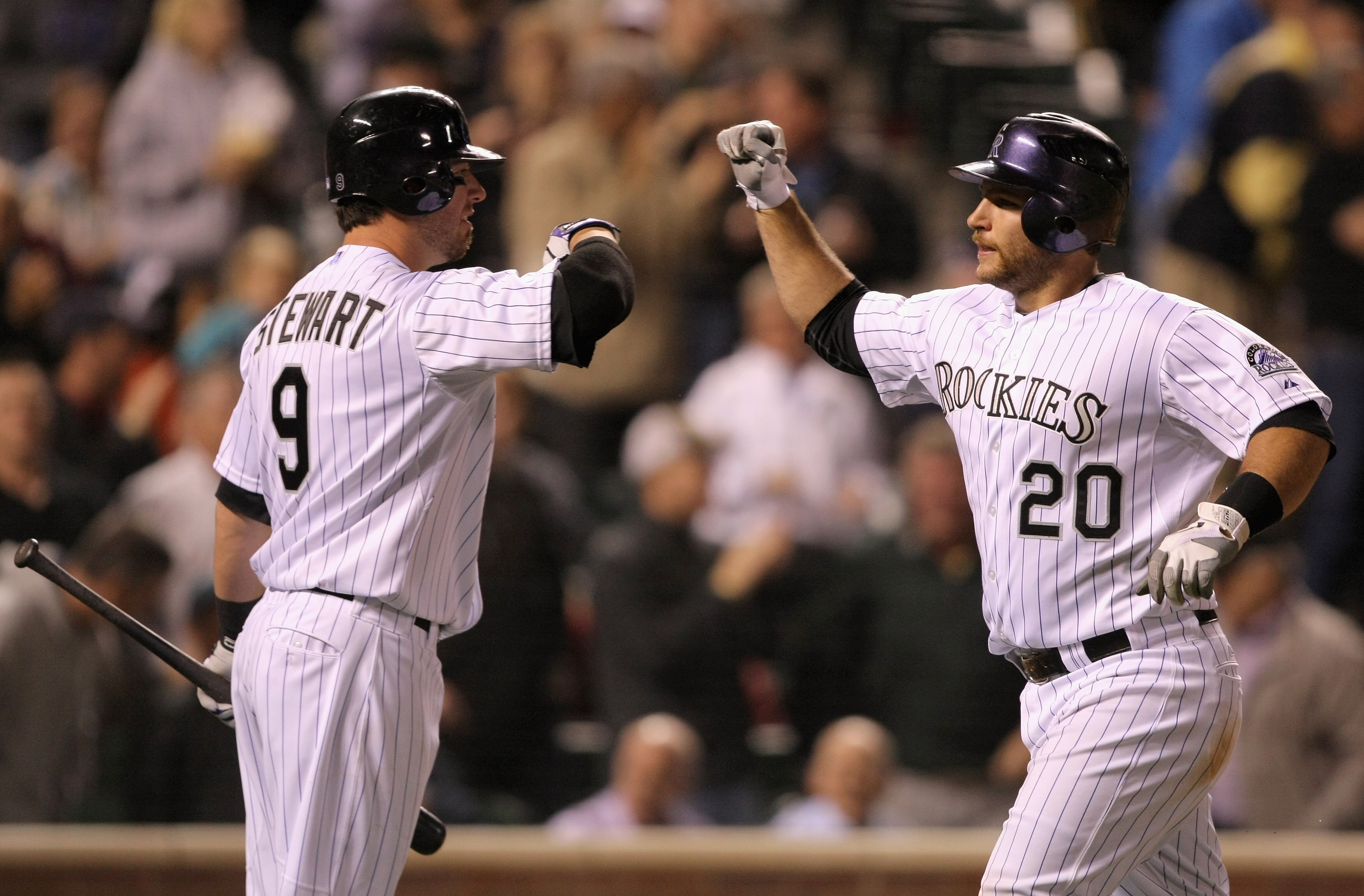 DENVER, CO - MAY 09:  Cacther Chris Iannetta #20 of the Colorado Rockies is welomed home by Ian Stewart #9 of the Colorado Rockies after his solo homerun off of starting pitcher Chris Capuano #38 of the New York Mets in the seventh inning at Coors Field o