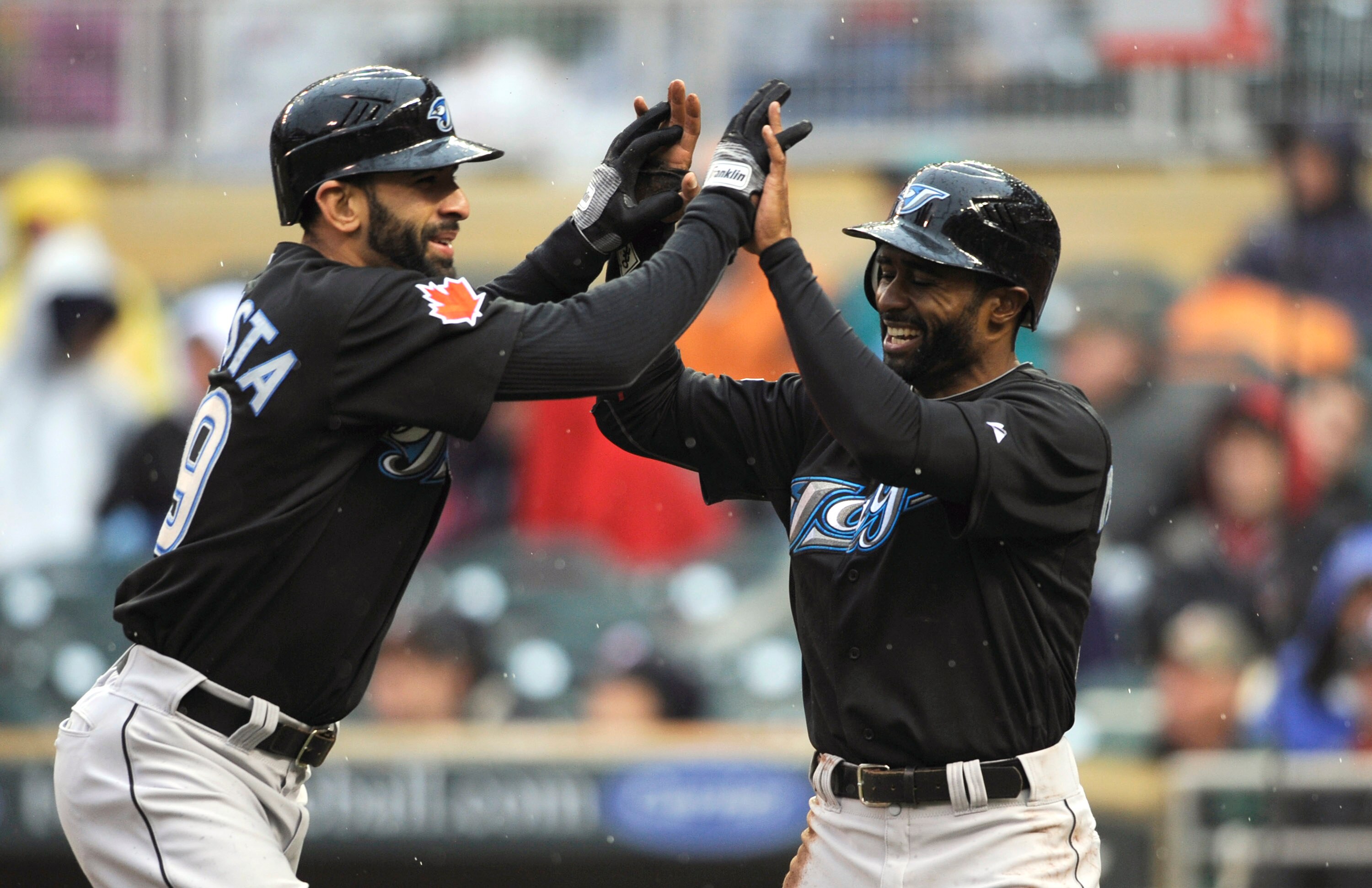 MINNEAPOLIS, MN - MAY 14: Jose Bautista #19 and Corey Patterson #16 of the Toronto Blue Jays celebrate a two-run home run by Bautista against the Minnesota Twins during the eleventh inning on May 14, 2011 at Target Field in Minneapolis, Minnesota. Blue Ja