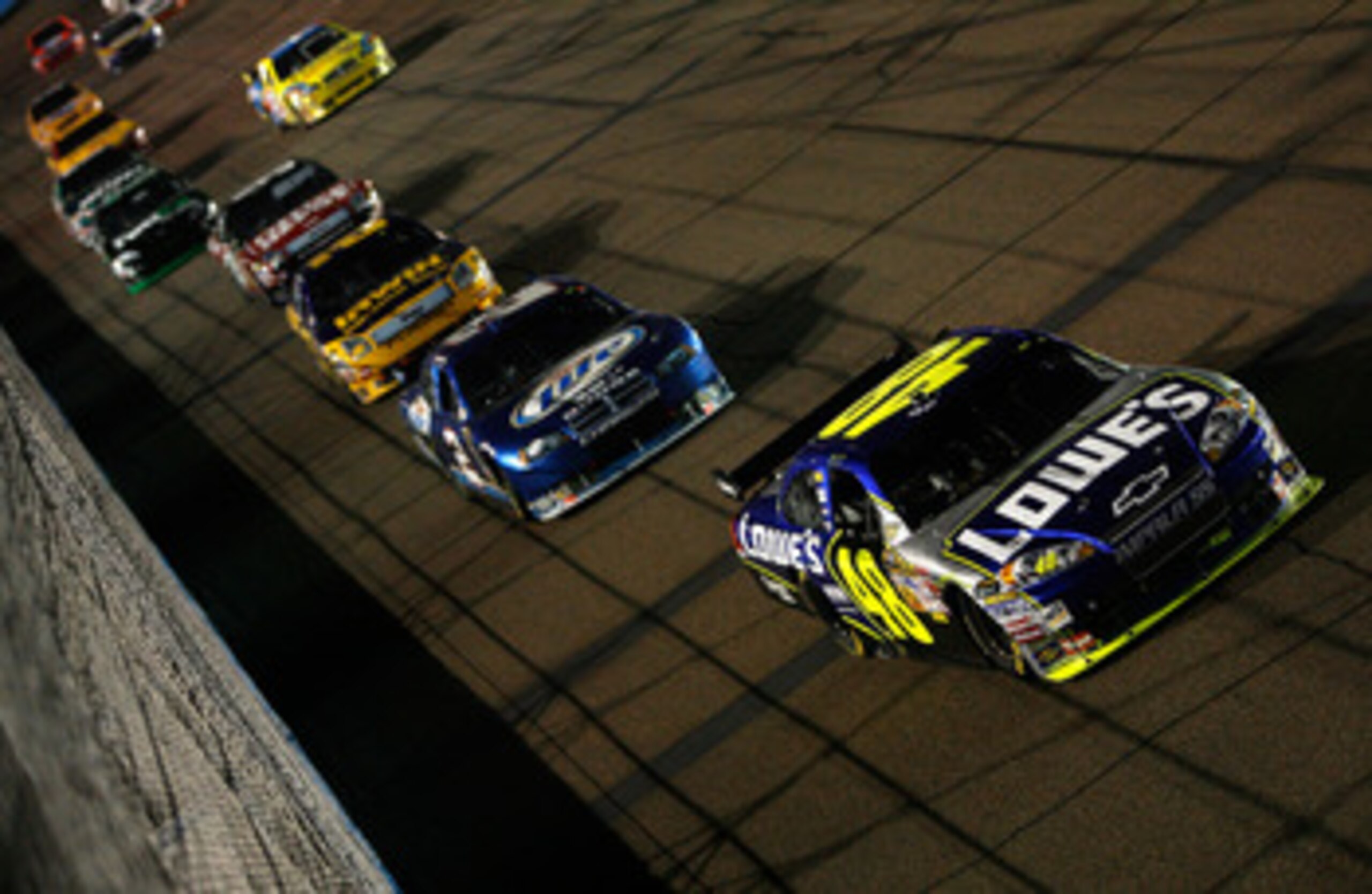 AVONDALE, AZ - NOVEMBER 09:  Jimmie Johnson, driver of the #48 Lowe's Chevrolet leads Kurt Busch, driver of the #2 Miller Lite Dodge, Jamie McMurray, driver of the IRWIN Industrial Tools Ford and Carl Edwards, driver of the #99 Office Depot Ford during th