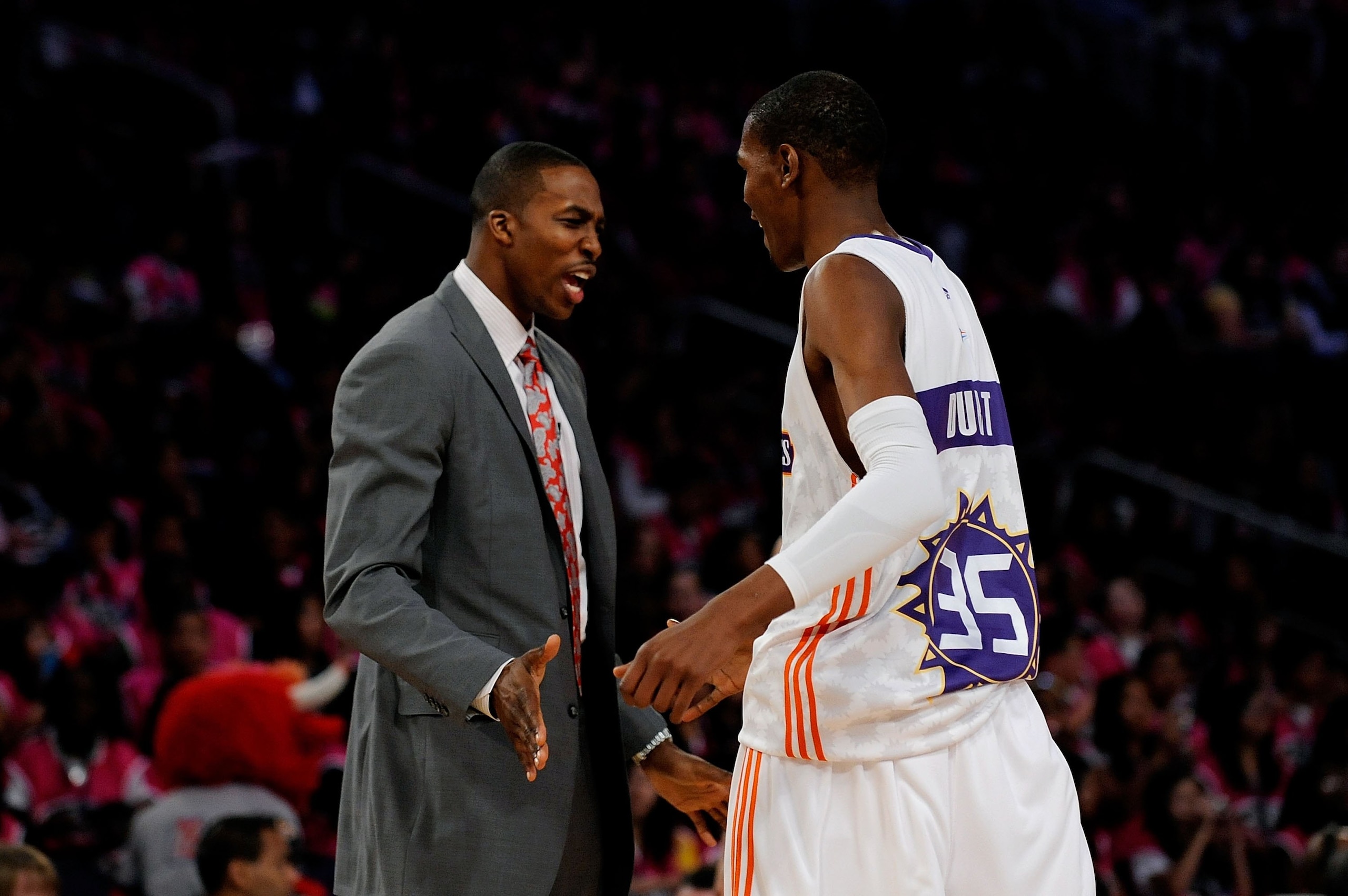 PHOENIX - FEBRUARY 13:  Assistant coach Dwight Howard high fives Kevin Durant #35 of the Sophomore team during the T-Mobile Rookie Challenge & Youth Jam part of 2009 NBA All-Star Weekend at US Airways Center on February 13, 2009 in Phoenix, Arizona.  NOTE