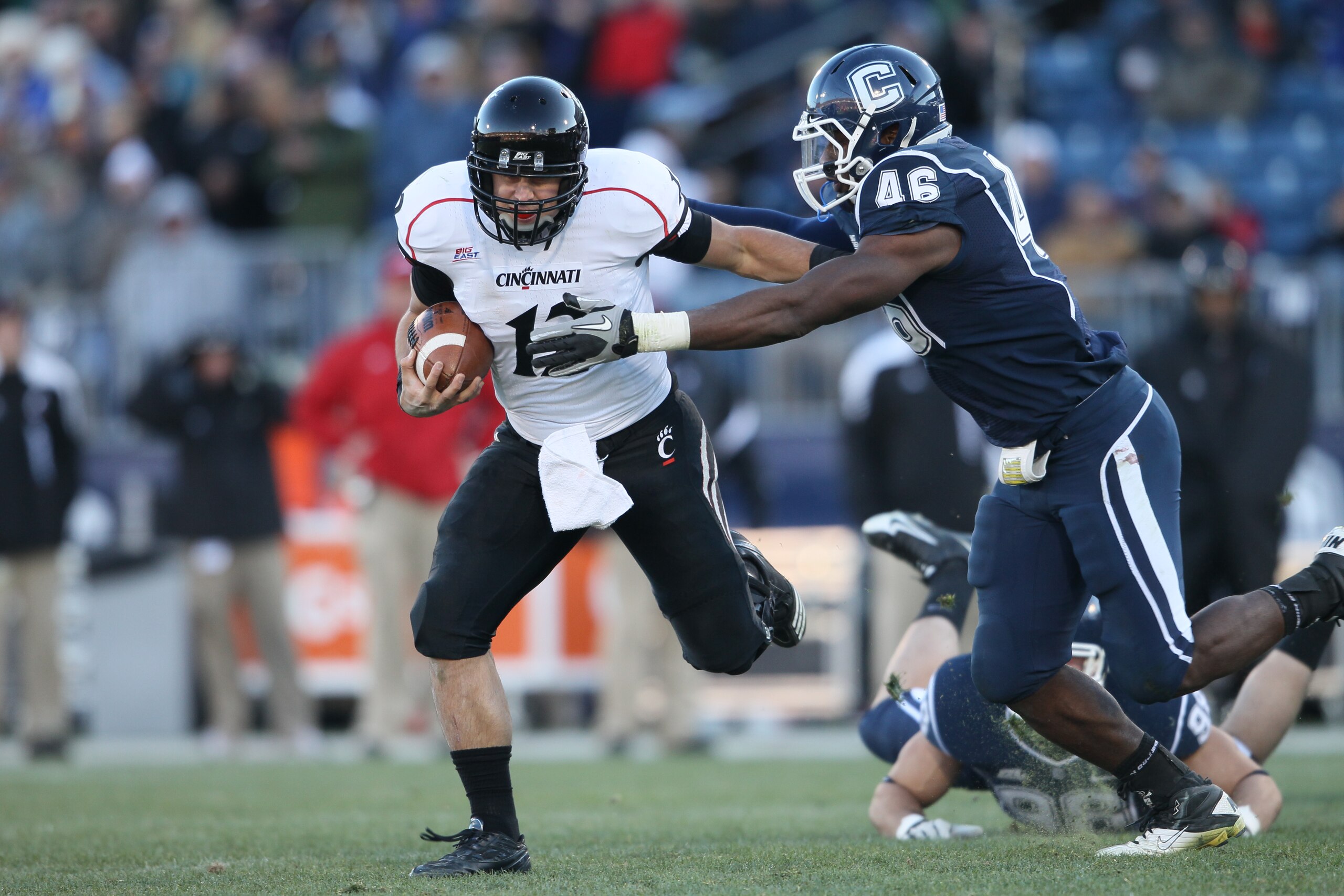 EAST HARTFORD, CT - NOVEMBER 27: Zach Collaros #12 of the Cincinnati Bearcats carries the ball as Sio Moore #46 of the Connecticut Huskies makes the tackle on November 27, 2010 at Rentschler Field in East Hartford, Connecticut. The Huskies defeated the B EAST HARTFORD, CT - NOVEMBER 27: Zach Collaros #12 of the Cincinnati Bearcats carries the ball as Sio Moore #46 of the Connecticut Huskies makes the tackle on November 27, 2010 at Rentschler Field in East Hartford, Connecticut. The Huskies defeated the B