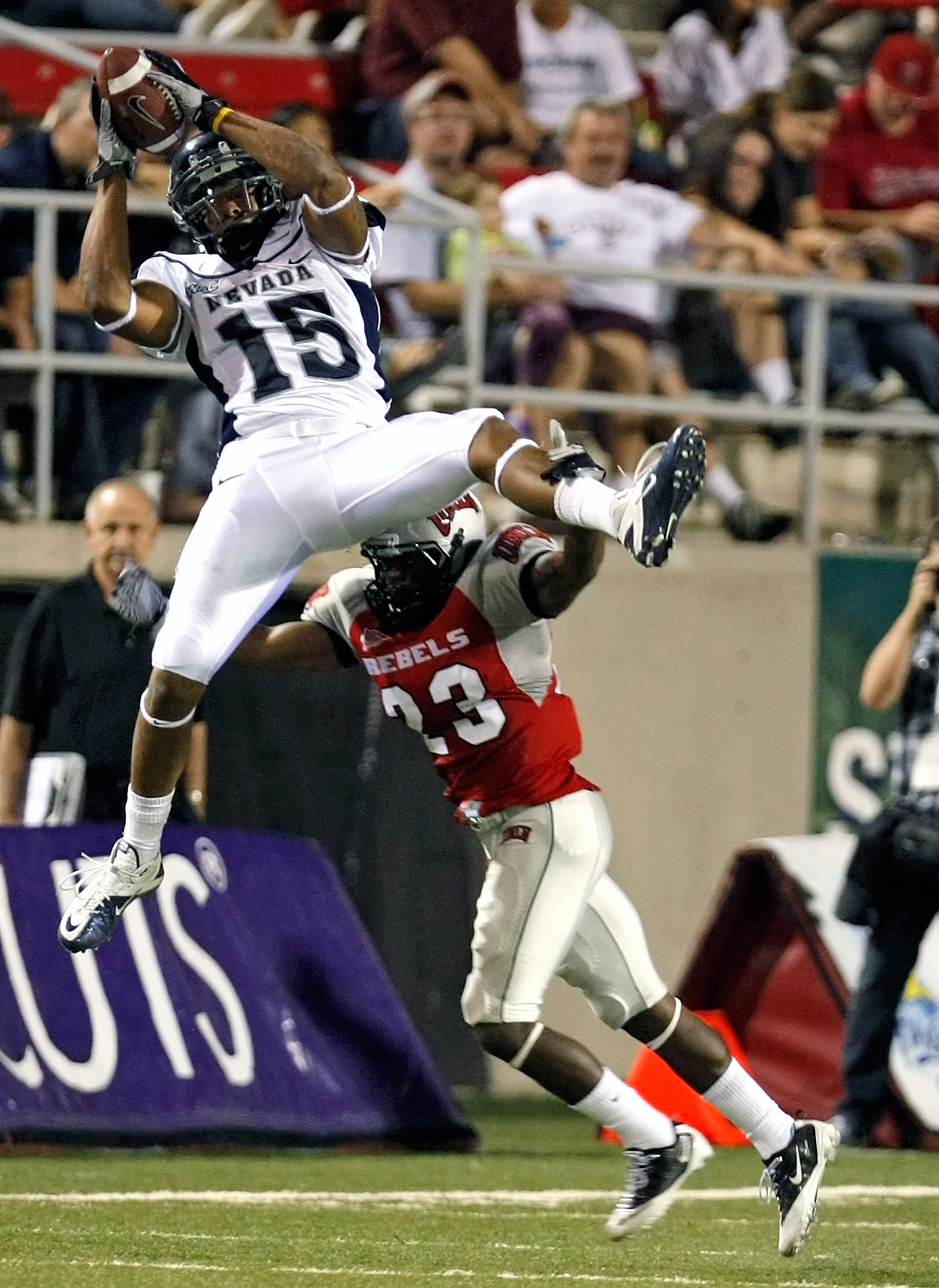 LAS VEGAS - OCTOBER 02: Rishard Matthews #15 of the Nevada Reno Wolf Pack grabs a reception over Sidney Hodge #23 UNLV Rebels during the third quarter of their game at Sam Boyd Stadium October 2, 2010 in Las Vegas, Nevada. Nevada Reno won 44-26. (Photo LAS VEGAS - OCTOBER 02: Rishard Matthews #15 of the Nevada Reno Wolf Pack grabs a reception over Sidney Hodge #23 UNLV Rebels during the third quarter of their game at Sam Boyd Stadium October 2, 2010 in Las Vegas, Nevada. Nevada Reno won 44-26. (Photo