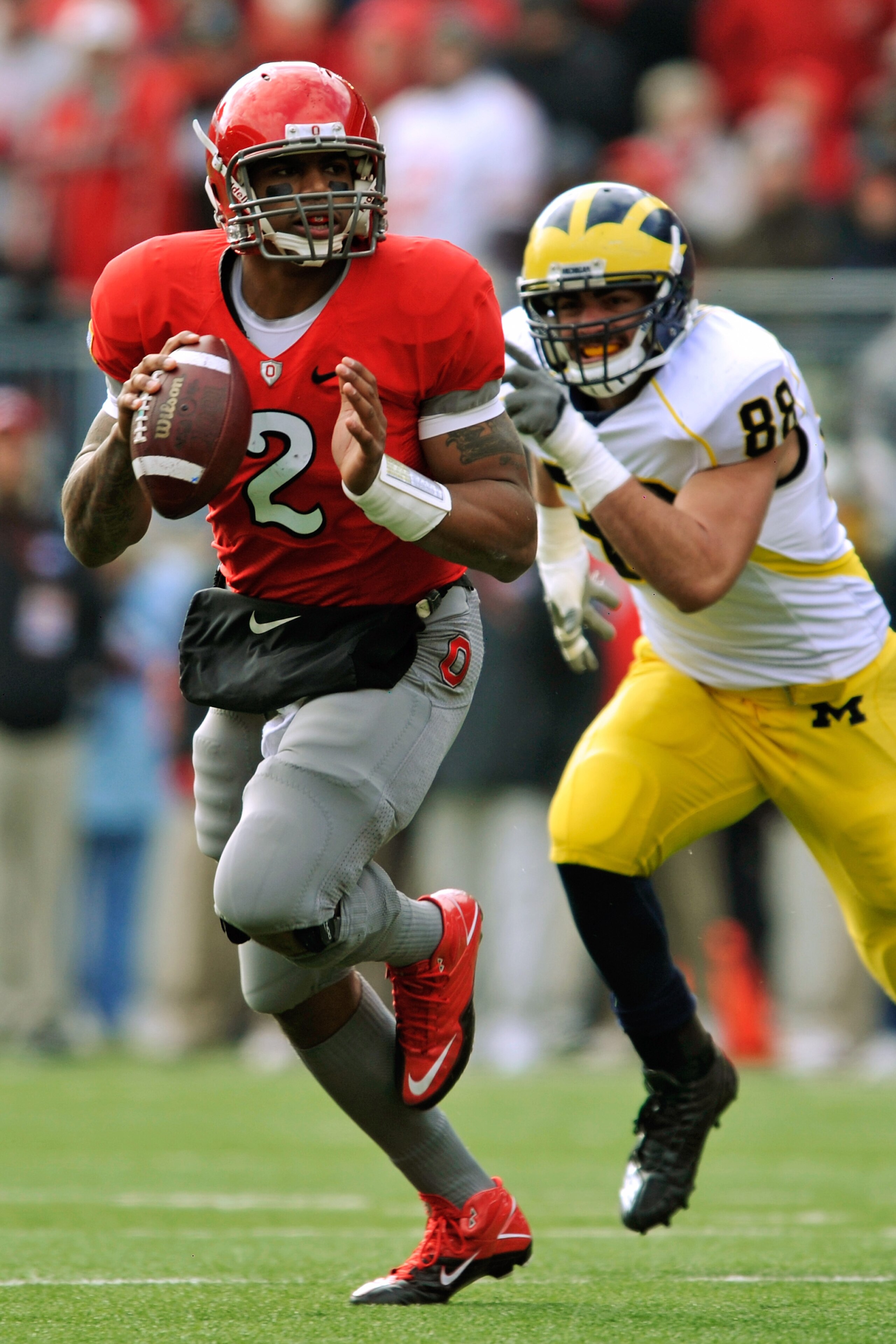 COLUMBUS, OH - NOVEMBER 27: Quarterback Terrelle Pryor #2 of the Ohio State Buckeyes rolls out of the pocket looking for his receiver as Craig Roh #88 of the Michigan Wolverines pursues at Ohio Stadium on November 27, 2010 in Columbus, Ohio. (Photo by J COLUMBUS, OH - NOVEMBER 27: Quarterback Terrelle Pryor #2 of the Ohio State Buckeyes rolls out of the pocket looking for his receiver as Craig Roh #88 of the Michigan Wolverines pursues at Ohio Stadium on November 27, 2010 in Columbus, Ohio. (Photo by J