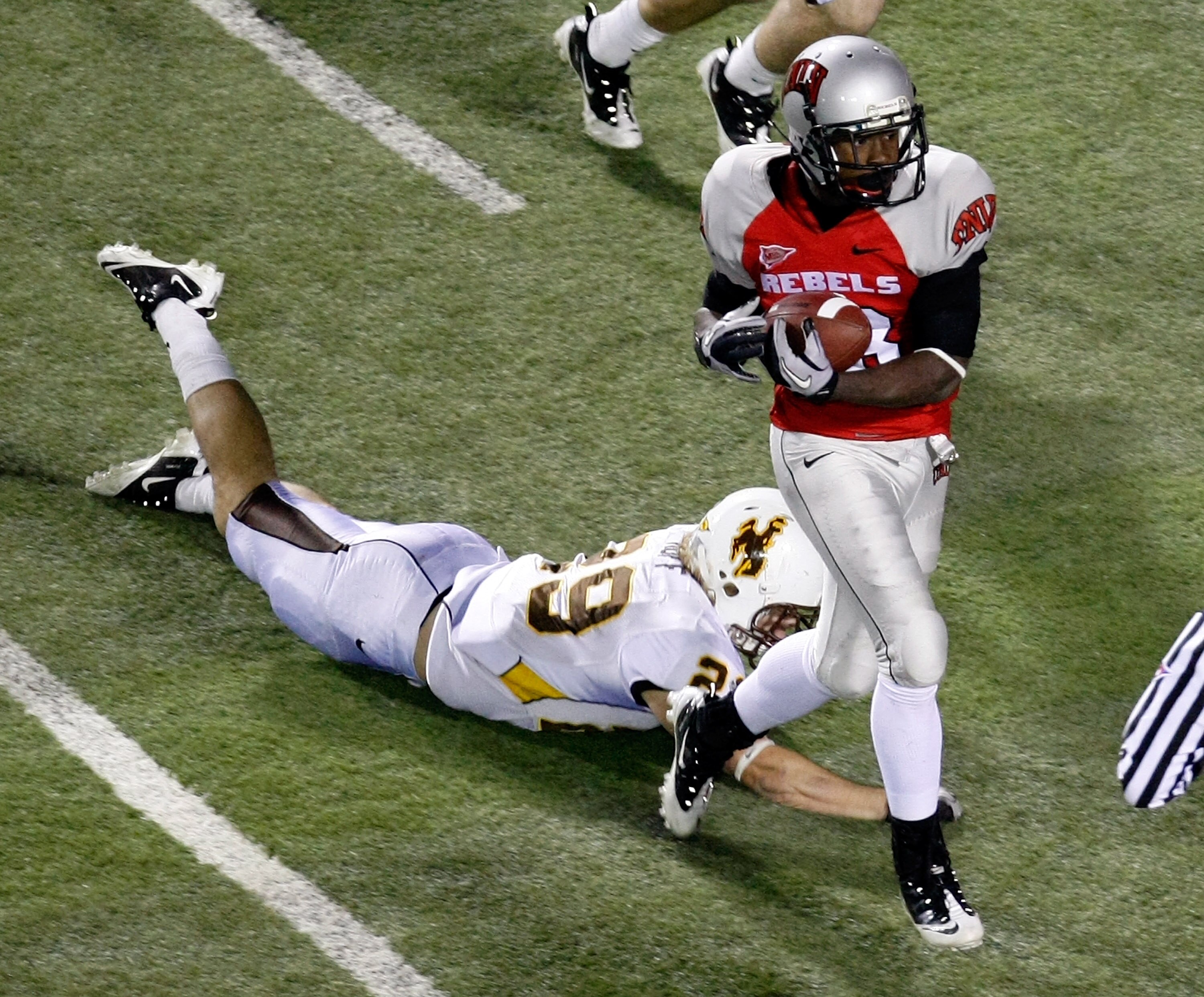 LAS VEGAS - NOVEMBER 13:  Marcus Sullivan #18 of the UNLV Rebels catches a 41-yard touchdown pass in front of Luke Ruff #29 of the Wyoming Cowboys during their game at Sam Boyd Stadium November 13, 2010 in Las Vegas, Nevada. UNLV won 42-16.  (Photo by Eth
