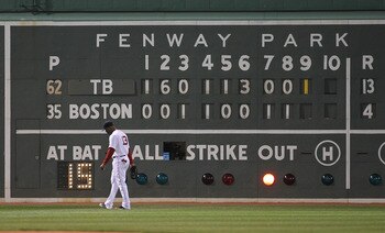 BOSTON, MA - APRIL 11:  Carl Crawford #13 of the Boston Red Sox walks into position during a game against the Tampa Bay Rays at Fenway Park April 11, 2011 in Boston, Massachusetts. (Photo by Jim Rogash/Getty Images)