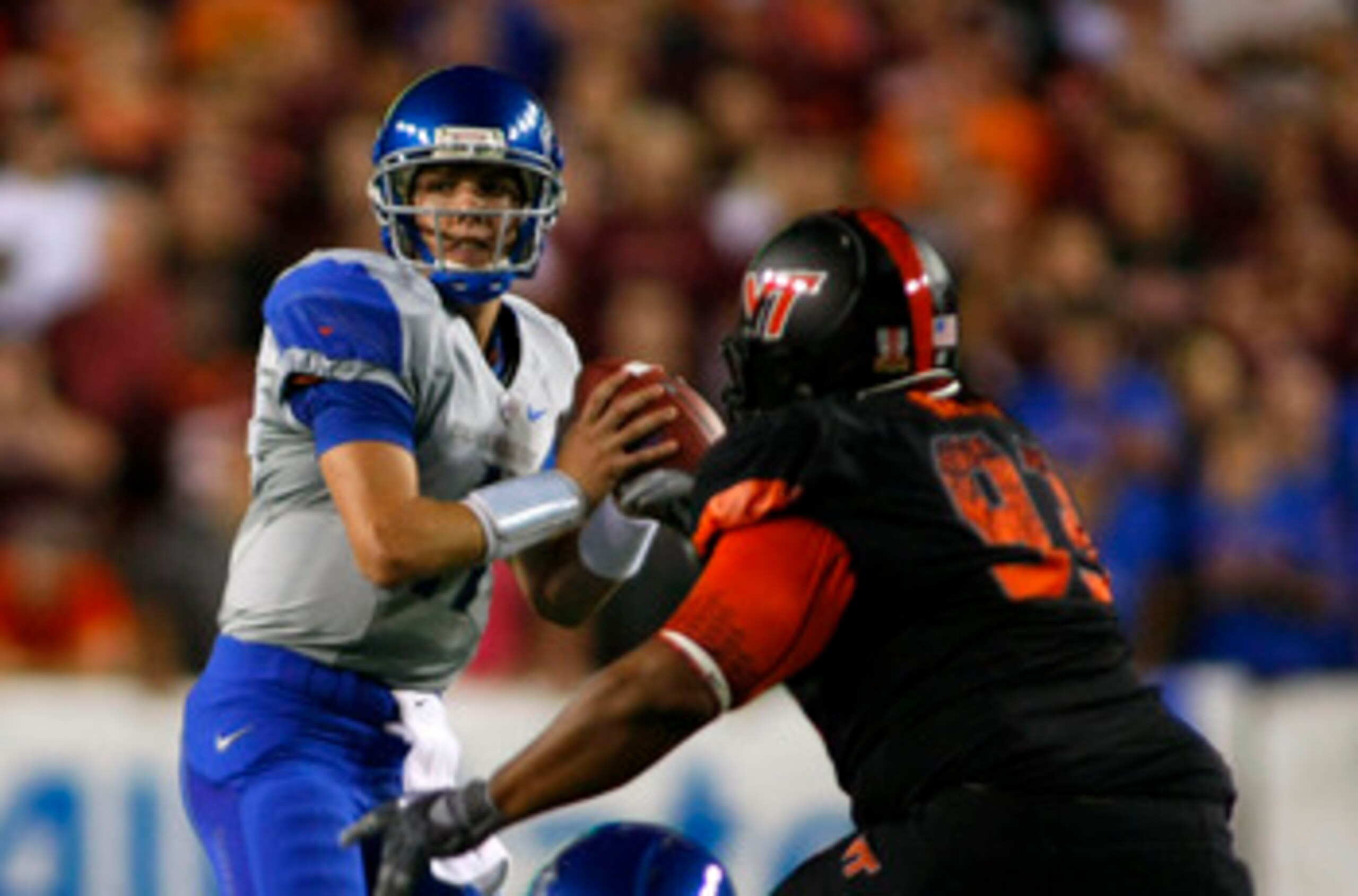 LANDOVER, MD - SEPTEMBER 06:  Quarterback Kellen Moore #11 of the Boise State Broncos prepares to pass as defensive tackle Kwamaine Battle #93 of the Virginia Tech Hokies defends at FedExField on September 6, 2010 in Landover, Maryland.  (Photo by Geoff B