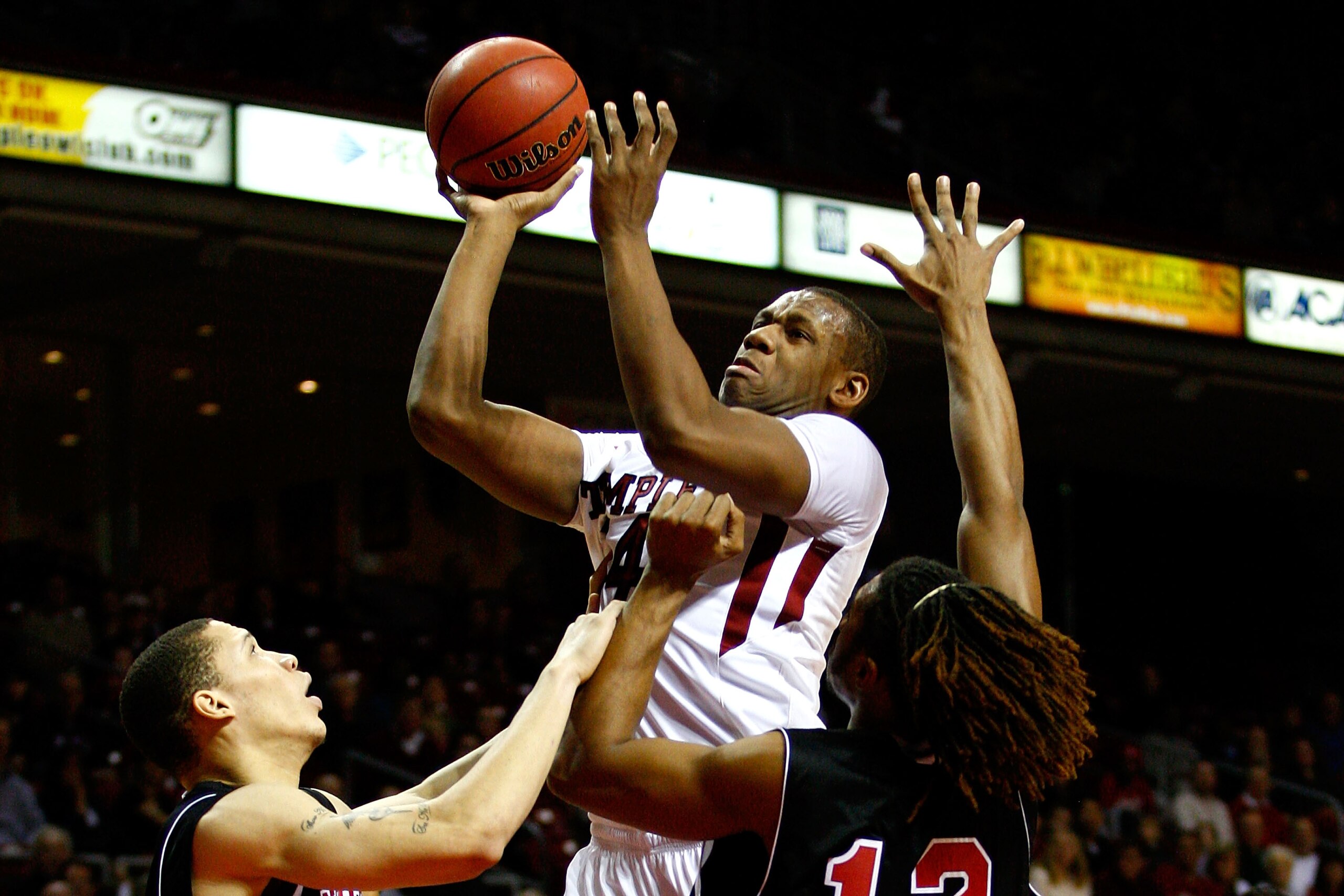PHILADELPHIA, PA - DECEMBER 18: Lavoy Allen #24 of the Temple Owls attempts a shot against Lee Fisher #30 (L) and Nate Rucker #12 of the Northern Illinois Huskies at the Liacouras Center on December 18, 2010 in Philadelphia, Pennsylvania. (Photo by Chri PHILADELPHIA, PA - DECEMBER 18: Lavoy Allen #24 of the Temple Owls attempts a shot against Lee Fisher #30 (L) and Nate Rucker #12 of the Northern Illinois Huskies at the Liacouras Center on December 18, 2010 in Philadelphia, Pennsylvania. (Photo by Chri