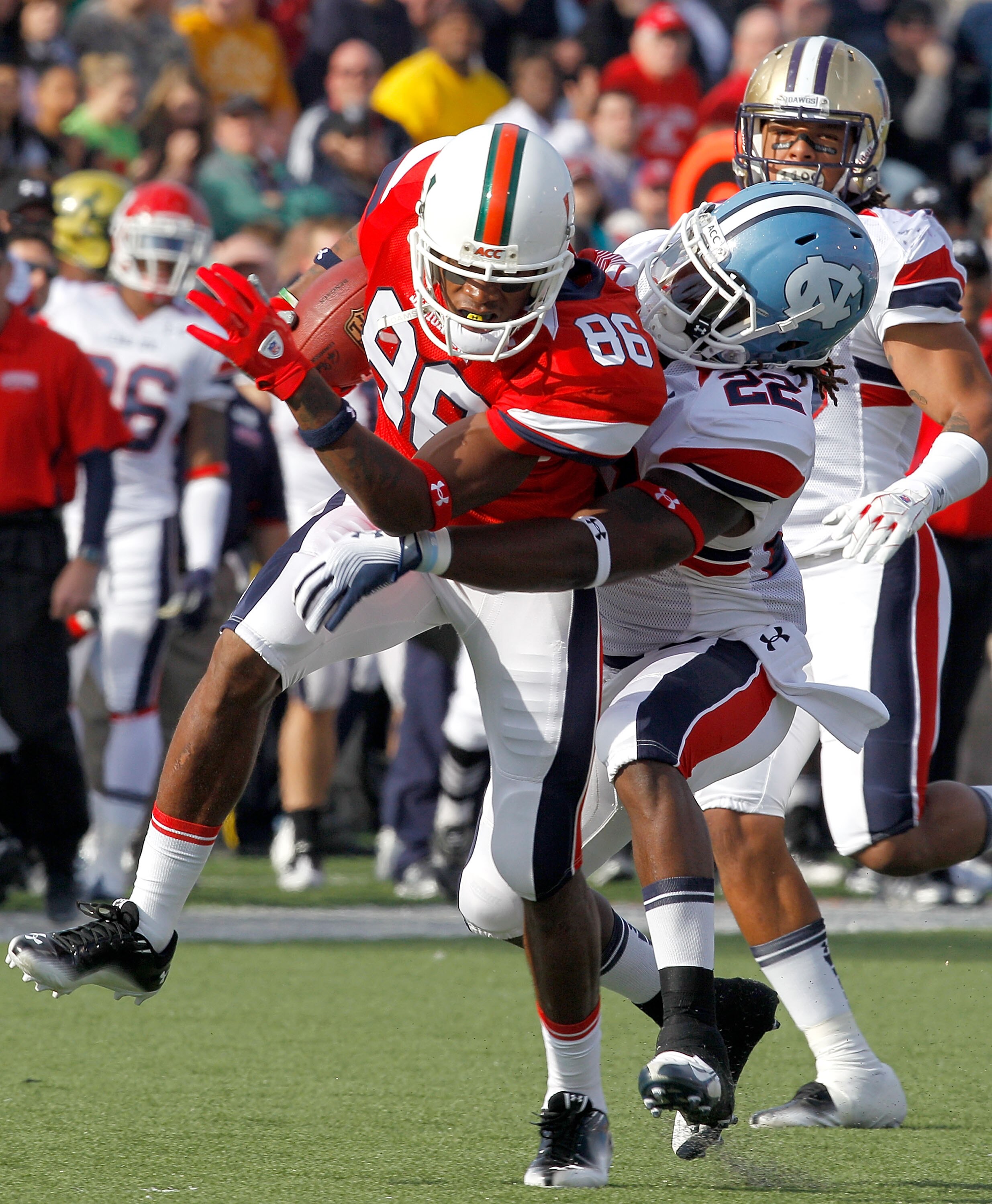 MOBILE, AL - JANUARY 29: Wide receiver Leonard Hankerson #86  of the South Team is tackled by Ryan Kerrigan #91 and Da'Norris Searcy #22 of the North Team during the fisrt quarter of the Under Armour Senior Bowl January 29, 2011 at Ladd Peebles Stadium in