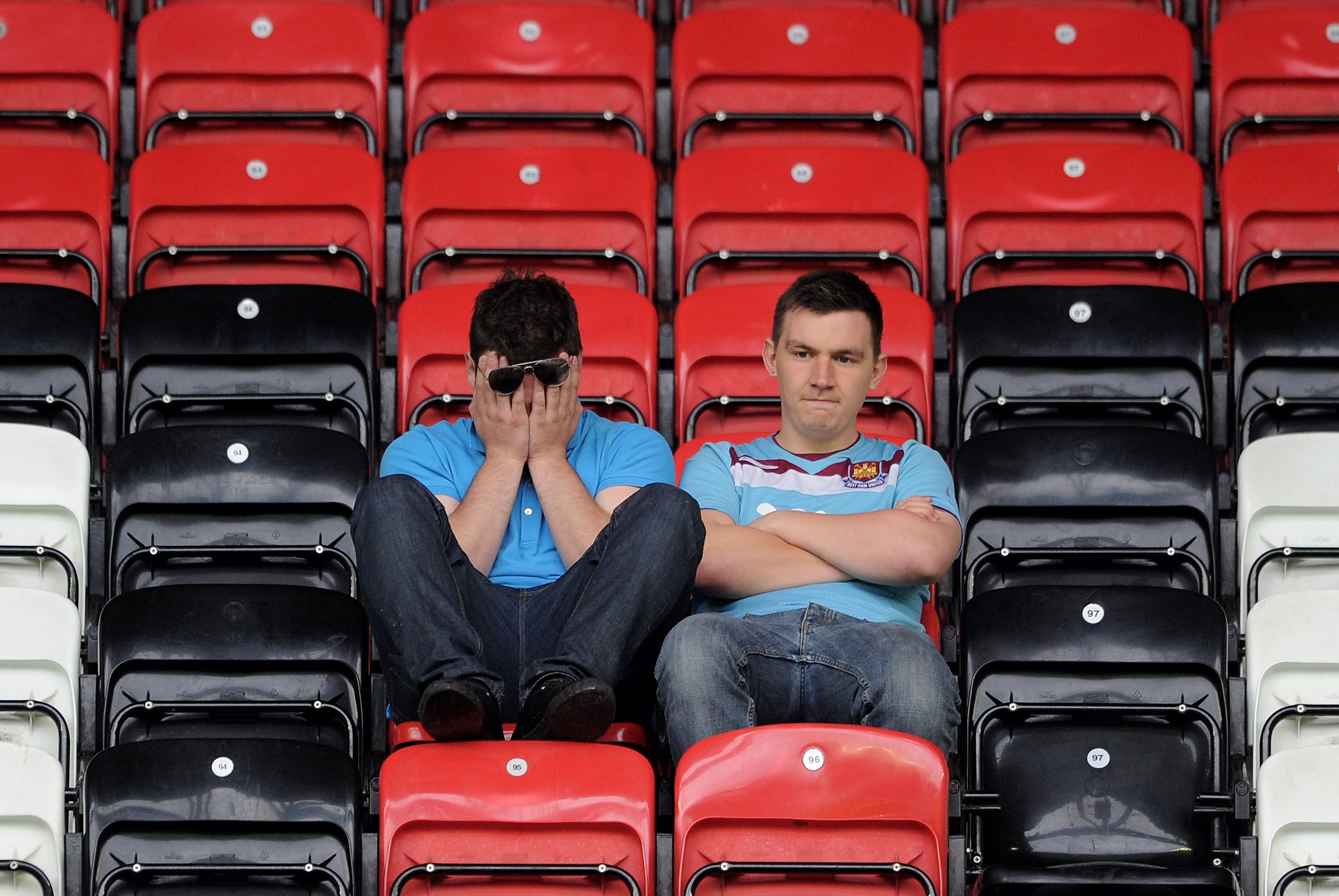 WIGAN, ENGLAND - MAY 15:  West Ham United fans look dejected following their relegation at the end of the Barclays Premier League match between Wigan Athletic and West Ham United at the DW Stadium on May 15, 2011 in Wigan, England.  (Photo by Chris Brunsk