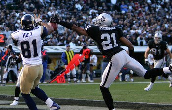 Oakland cornerback Nnamdi Asomugha prevents a touchdown by perfectly deflecting a pass away from St. Louis wide receiver Torry Holt in the Raiders 20-0 loss to the Rams on Sunday, December 17, 2006 at McAfee Coliseum in Oakland, California. (Photo by K. T