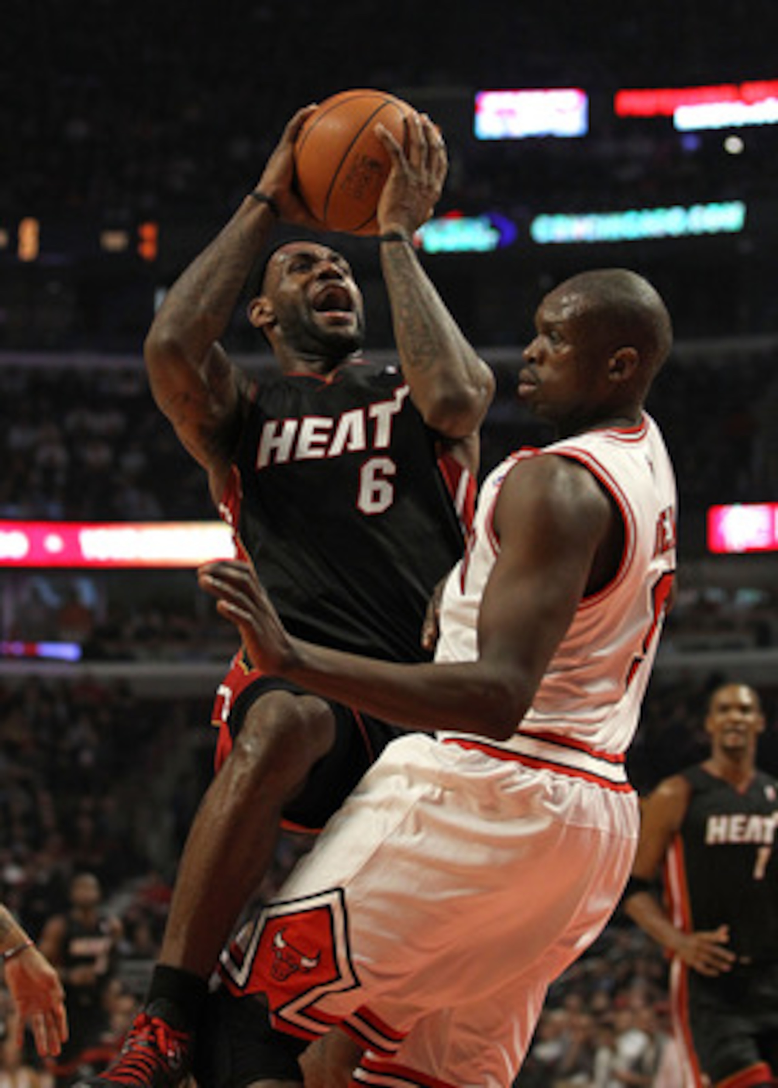 CHICAGO, IL - FEBRUARY 24: LeBron James #6 of the Miami Heat puts up a shot against Loul Deng #9 of the Chicago Bulls at the United Center on February 24, 2011 in Chicago, Illinois. NOTE TO USER: User expressly acknowledges and agrees that, by downloading