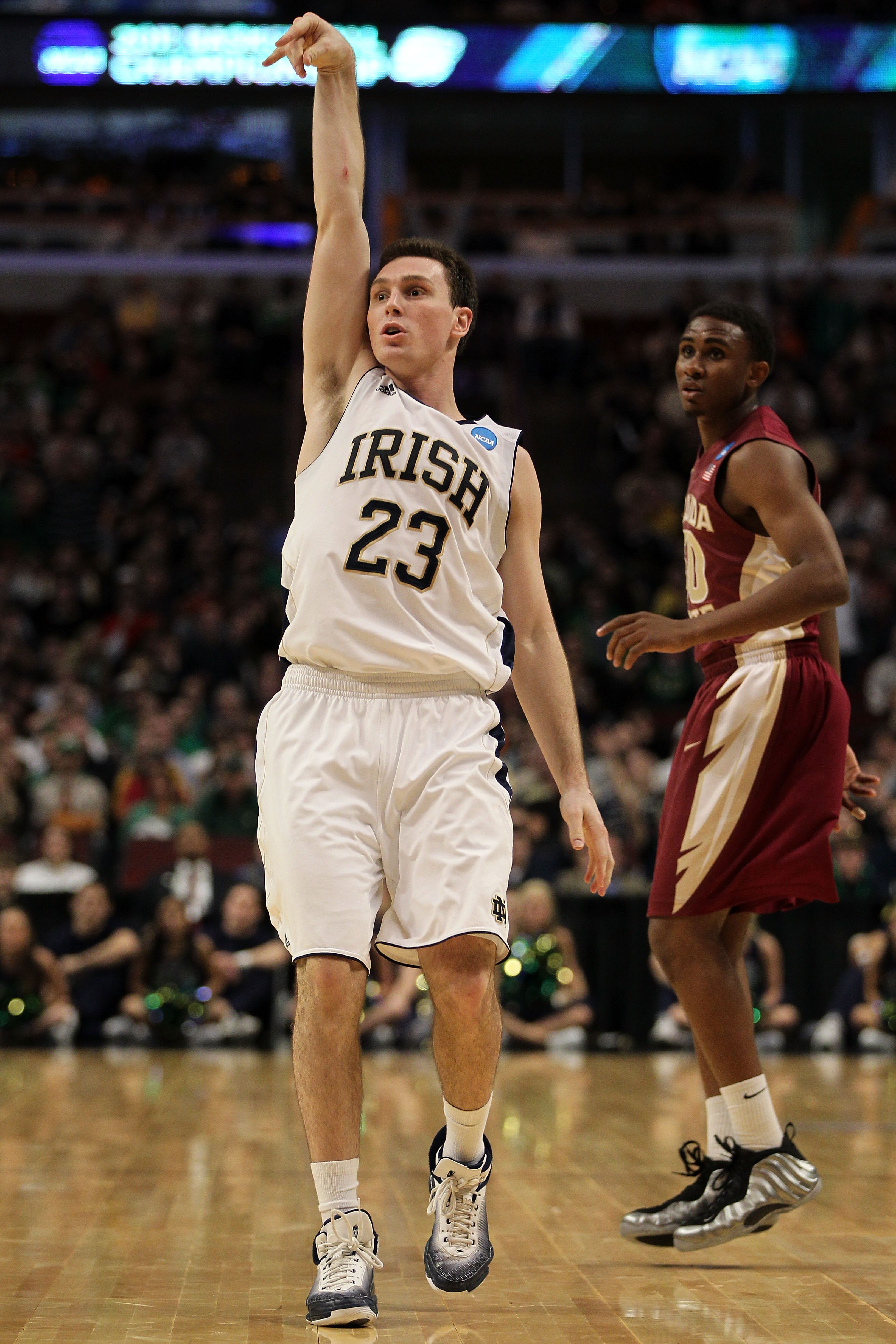 CHICAGO, IL - MARCH 20:  Ben Hansbrough #23 of the Notre Dame Fighting Irish follows through on a shot as Ian Miller #30 of the Florida State Seminoles looks on in the first half during the third round of the 2011 NCAA men's basketball tournament at the U